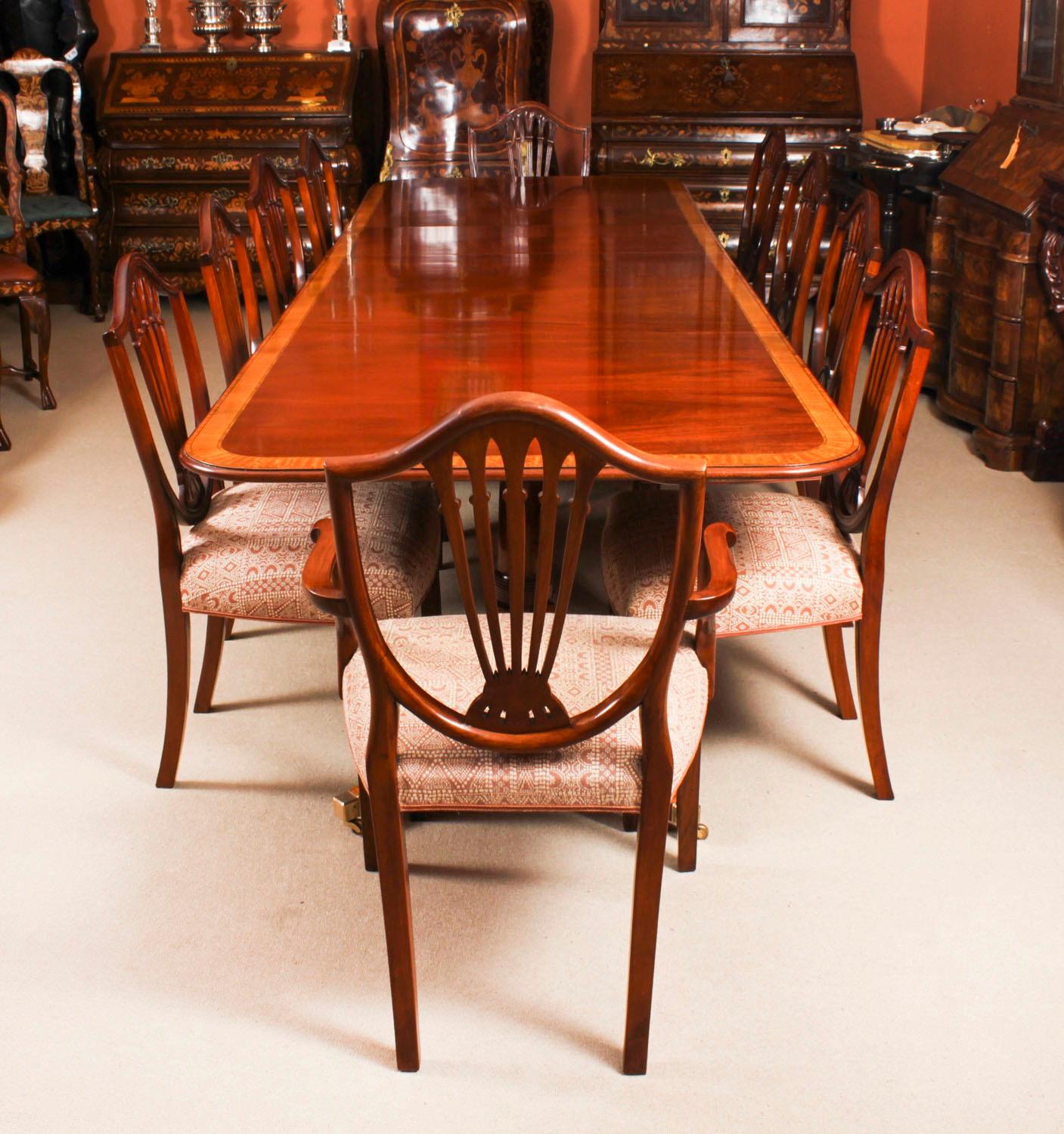 This is a superb dining set comprising a superb Vintage Regency Revival dining table  with ten Hepplewhite revival dining chairs all dating from the second half of the 20th Century.

The tabletop was crafted in beautiful flame mahogany and features