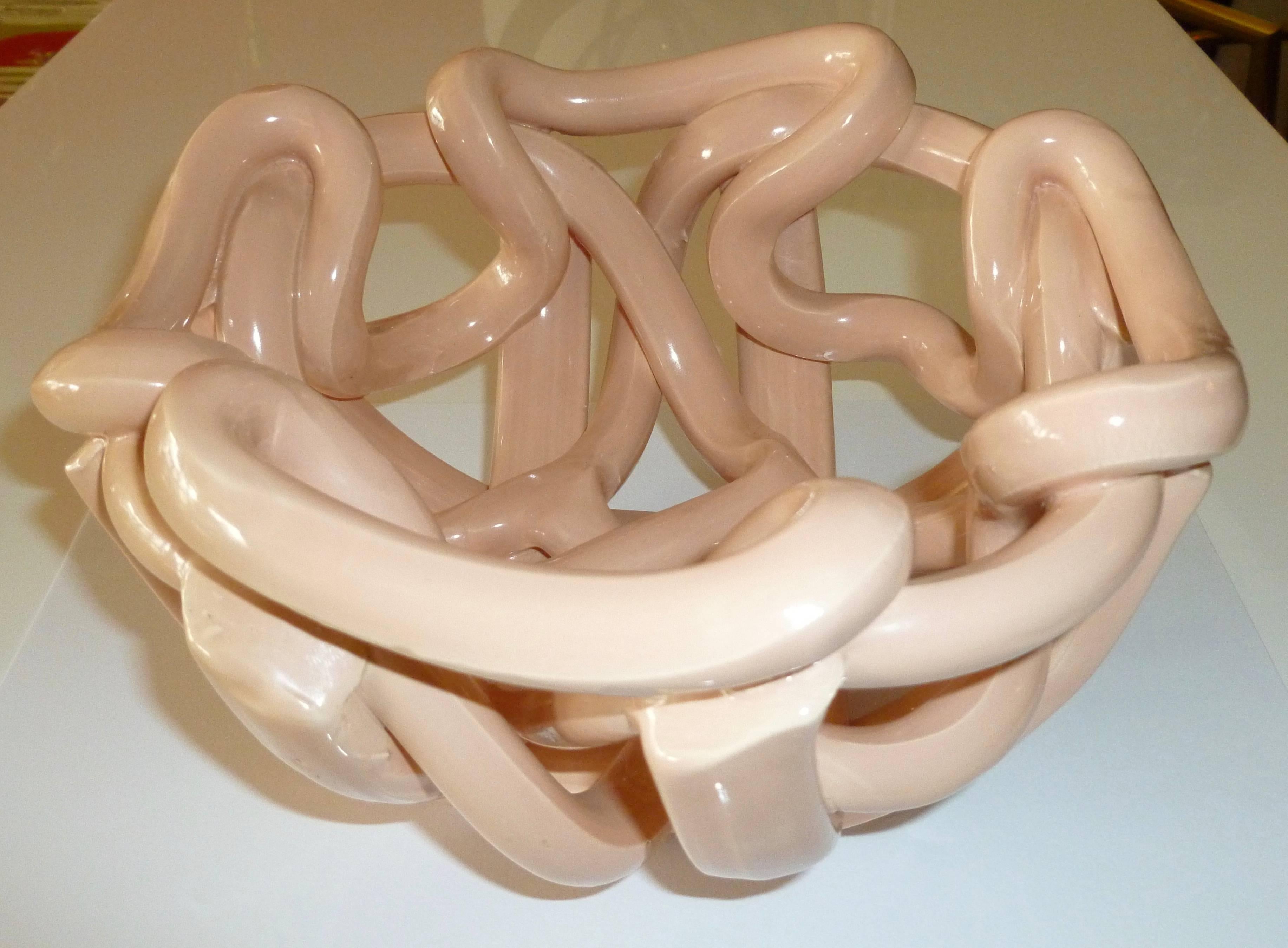 Intertwined ropes of ceramic make up this sculptural vintage bowl. The color is one of a peachy pink. Sorry the photos do not do justice to the lovely nature of this bowl. The color is unusual. It is from the 70's.

NOTE: THIS WILL BE ON SALE FOR A