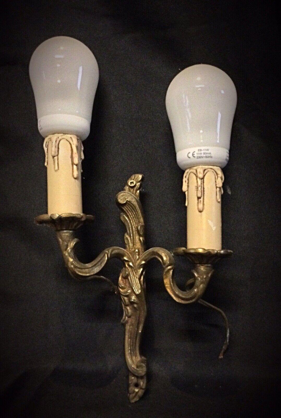 Add a touch of classic elegance to your interior with this vintage two-arm brass wall sconce. Dating from the 1940s, this beautifully crafted piece features ornate detailing and timeless style. Its warm brass finish exudes a vintage charm that can
