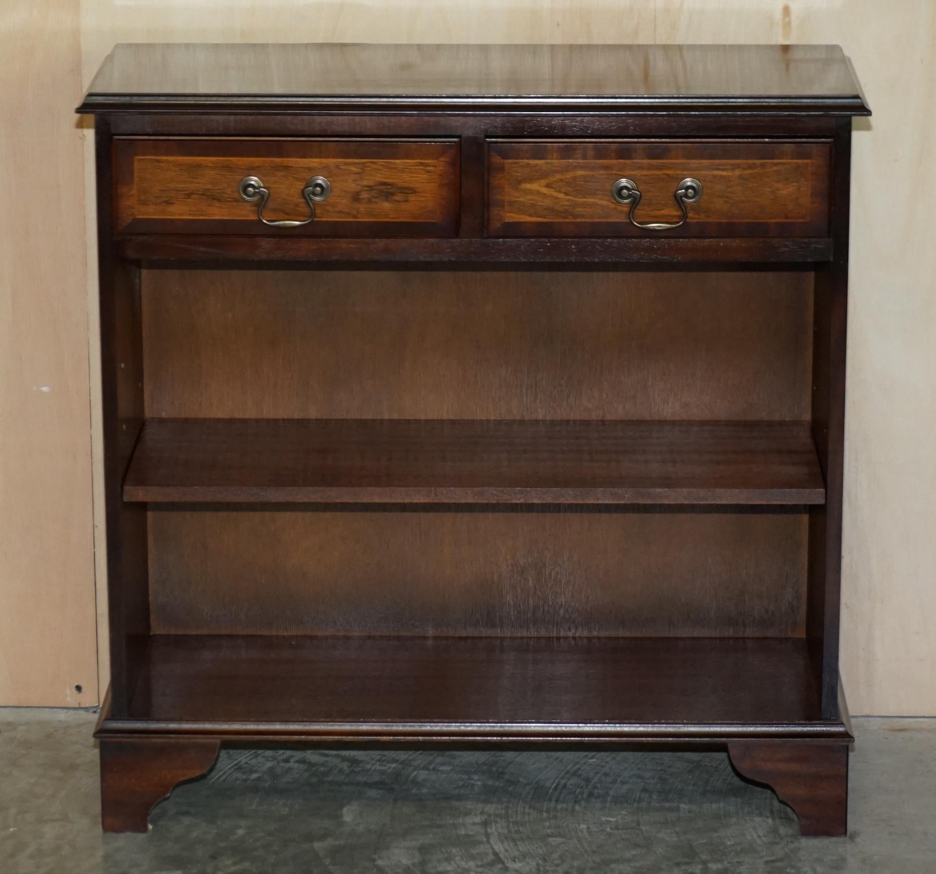 We are delighted to offer for sale this stunning vintage made in England dwarf open library bookcase in flamed mahogany with twin drawers.

It is a good looking and well made piece, it has a luxury flamed mahogany veneer over a hard wood frame,