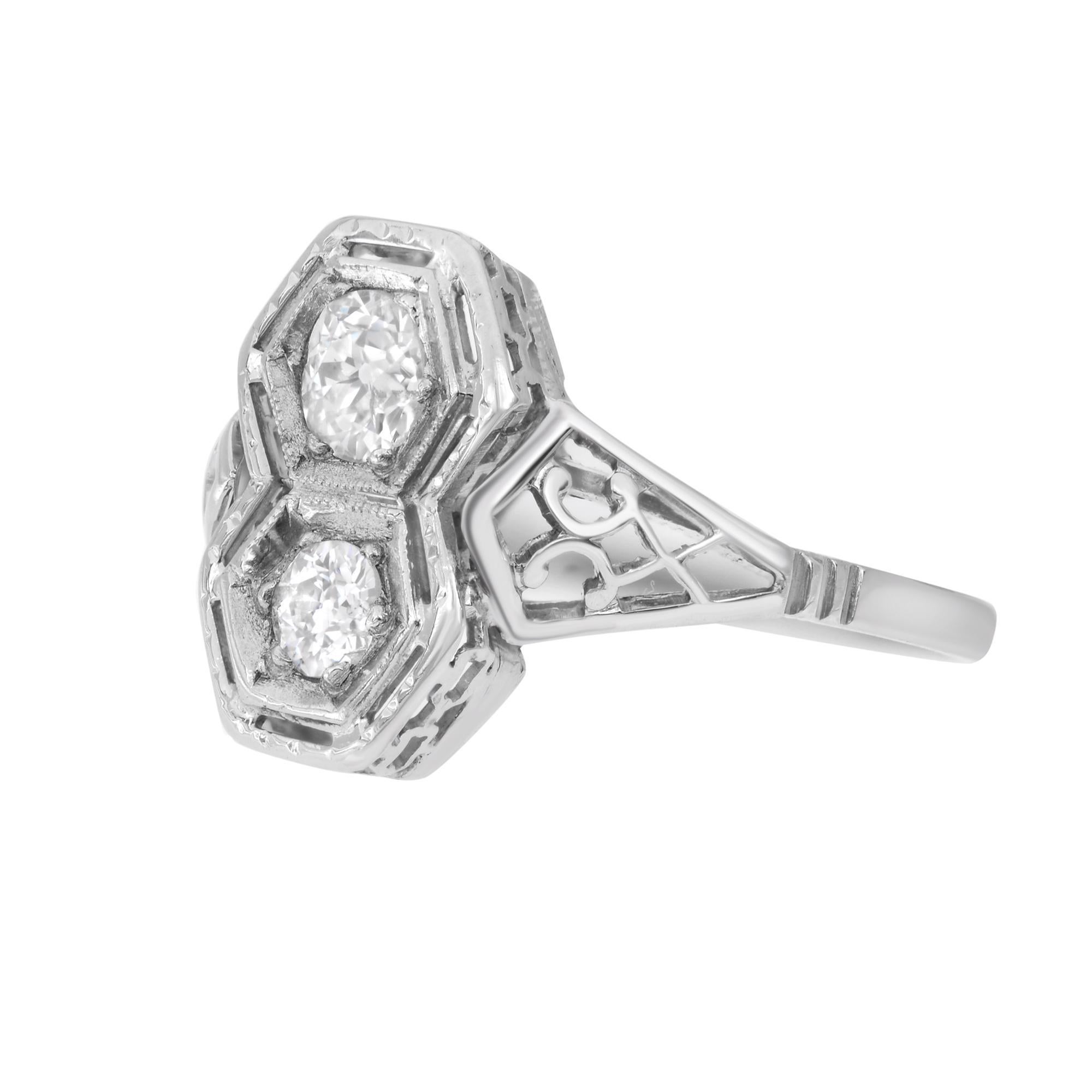 This gorgeous Vintage ring comes from the Art Deco era featuring two sparkling diamond stones set in a delicate and embellished filigree, 14k white gold mounting. This one of a kind handmade antique ring is a great addition to your jewelry