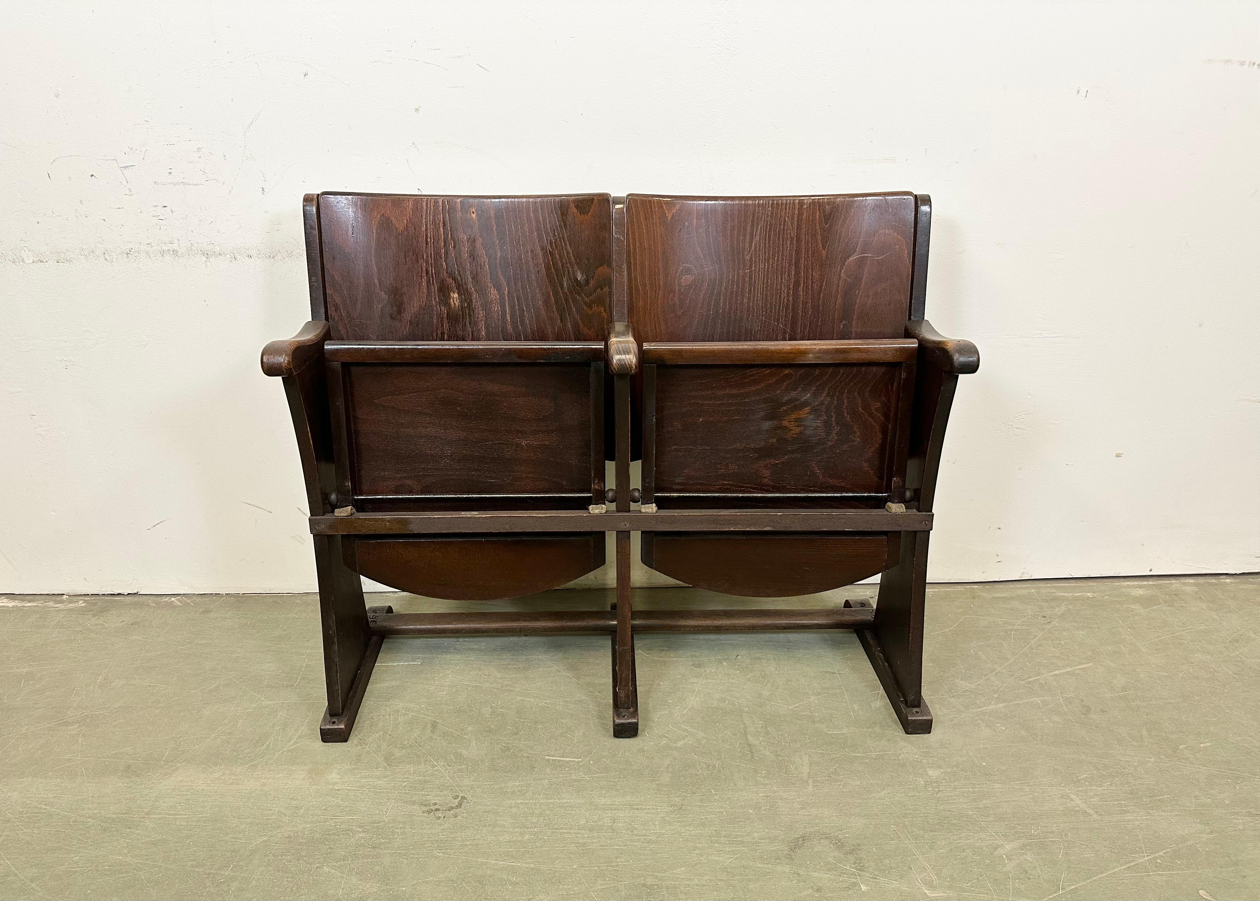 This two-seat cinema bench was produced by Thonet in former Czechoslovakia during the 1930s-1950s. The chairs are stable and can be placed anywhere. It is completely made of wood (partly solid wood, partly plywood). The seats fold upwards. The