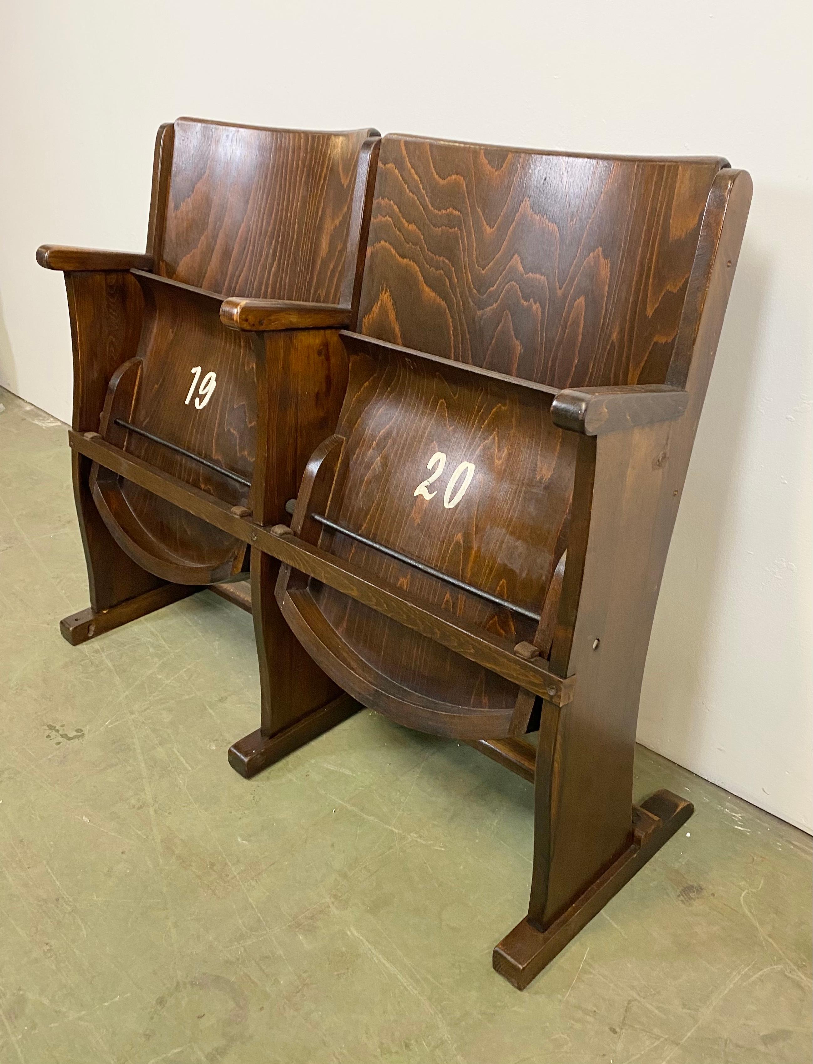This two-seat cinema bench was produced by Ton (former Thonet) in Czechoslovakia during the 1950s. The chairs are stabile and can be placed anywhere. It is completely made of wood (partly solid wood, partly plywood). The seats fold upwards. The