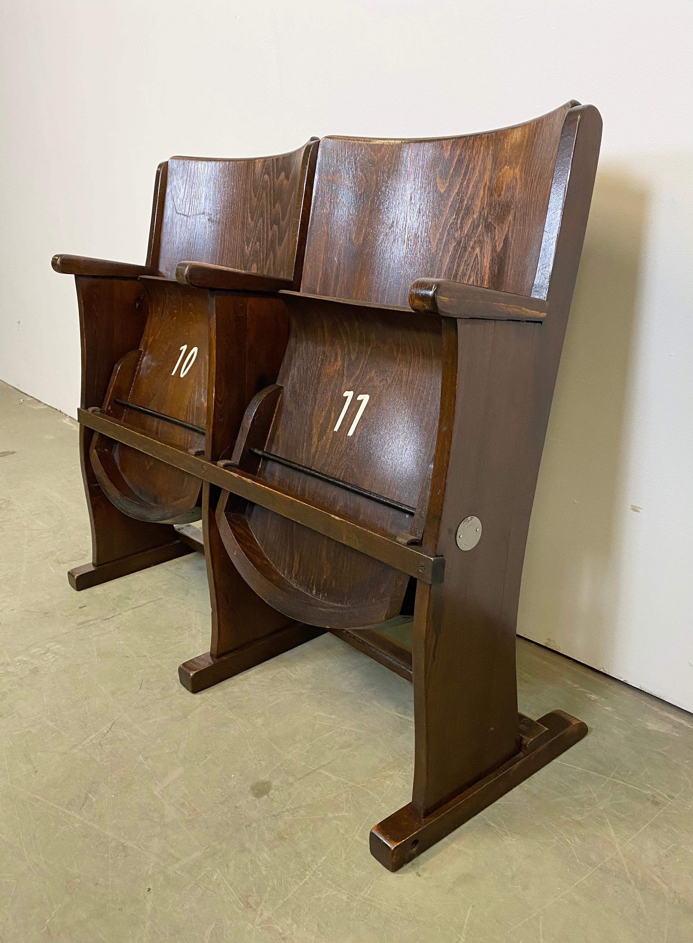 This two-seat cinema bench was produced by Ton (former Thonet) in Czechoslovakia during the 1950s. The chairs are stabile and can be placed anywhere. It is completely made of wood (partly solid wood, partly plywood). The seats fold upwards. The