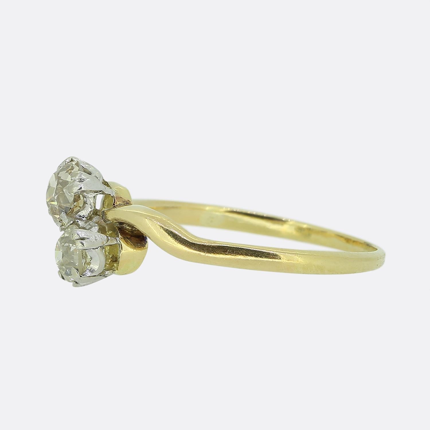 Here we have a lovely two-stone diamond crossover ring. This vintage piece has been crafted from 18ct yellow gold and showcases a duo of claw set round faceted old mine cut diamonds in a diagonal formation atop a swirling band. 

Condition: Used
