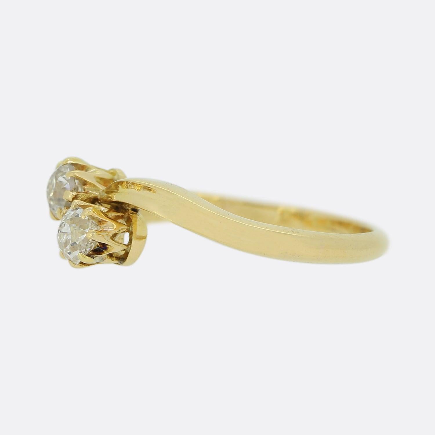 Here we have a classic two stone diamond ring. This vintage piece has been crafted from 18ct yellow gold and presents two closely claw set round old cut diamonds atop a thin swirling band. 

Condition: Used (Very Good)
Weight: 2.5 grams
Ring Size: K