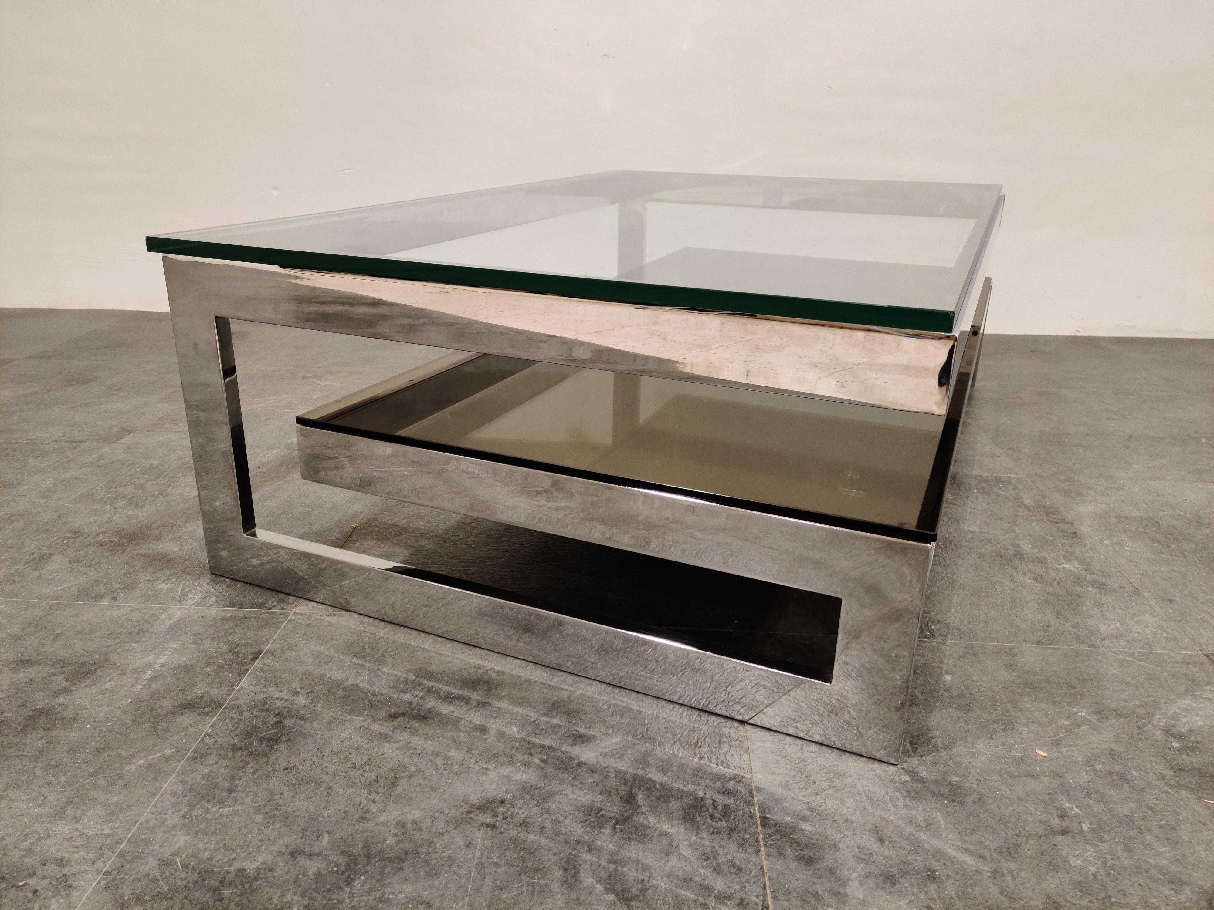 Chrome and thick clear glass two-tier coffee table manufactured by Belgochrom.

This table is a popular model and is referred to as the 'G' model

This is a rare chrome example. (An original chrome example, not brass that has been
