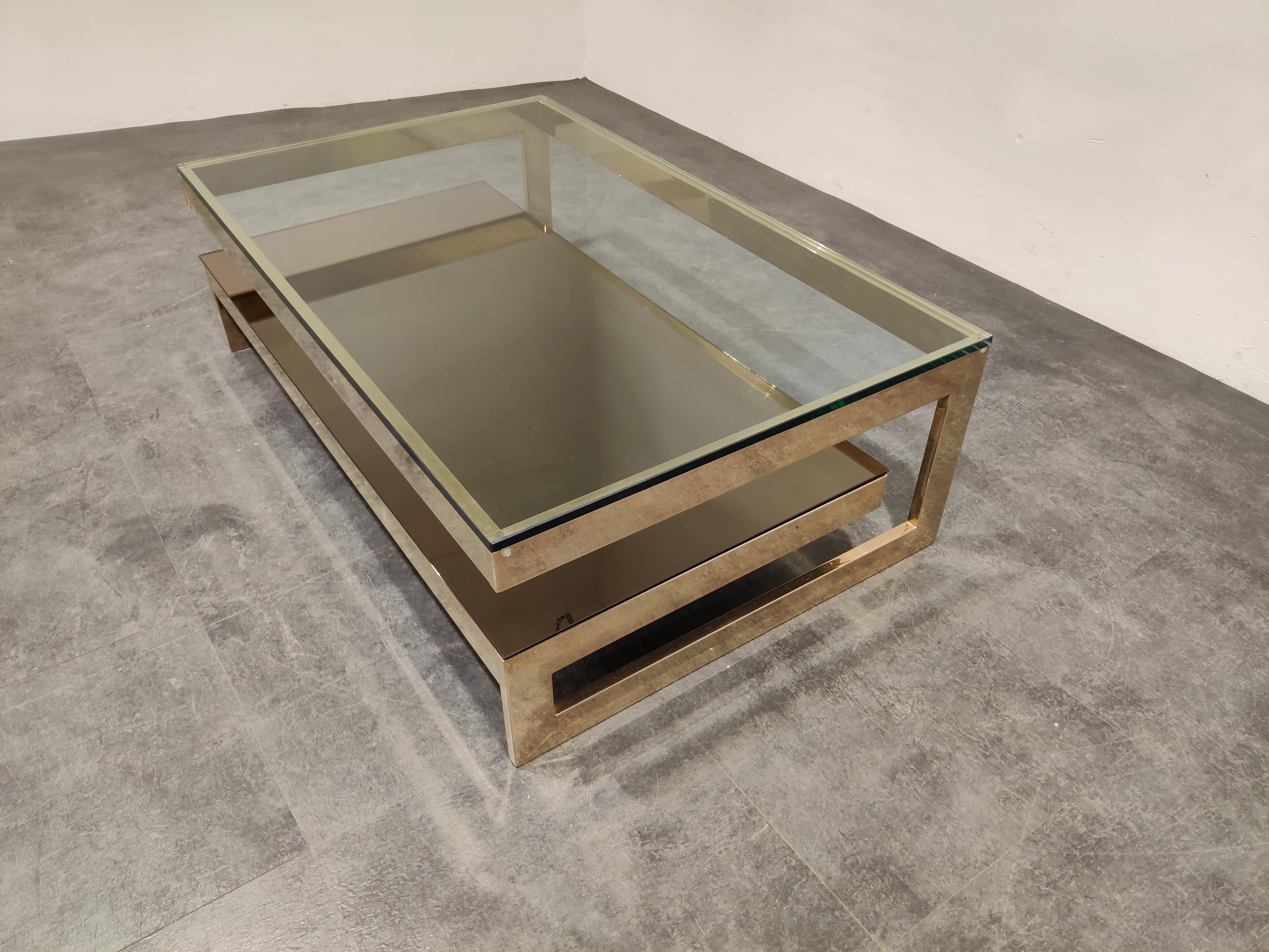 Quality 23-karat gold layered and thick clear glass two-tier coffee table manufactured by Belgochrom.

This table is a popular model and is referred to as the 'G' model

Belgochrom produced quality furniture pieces with a luxurious