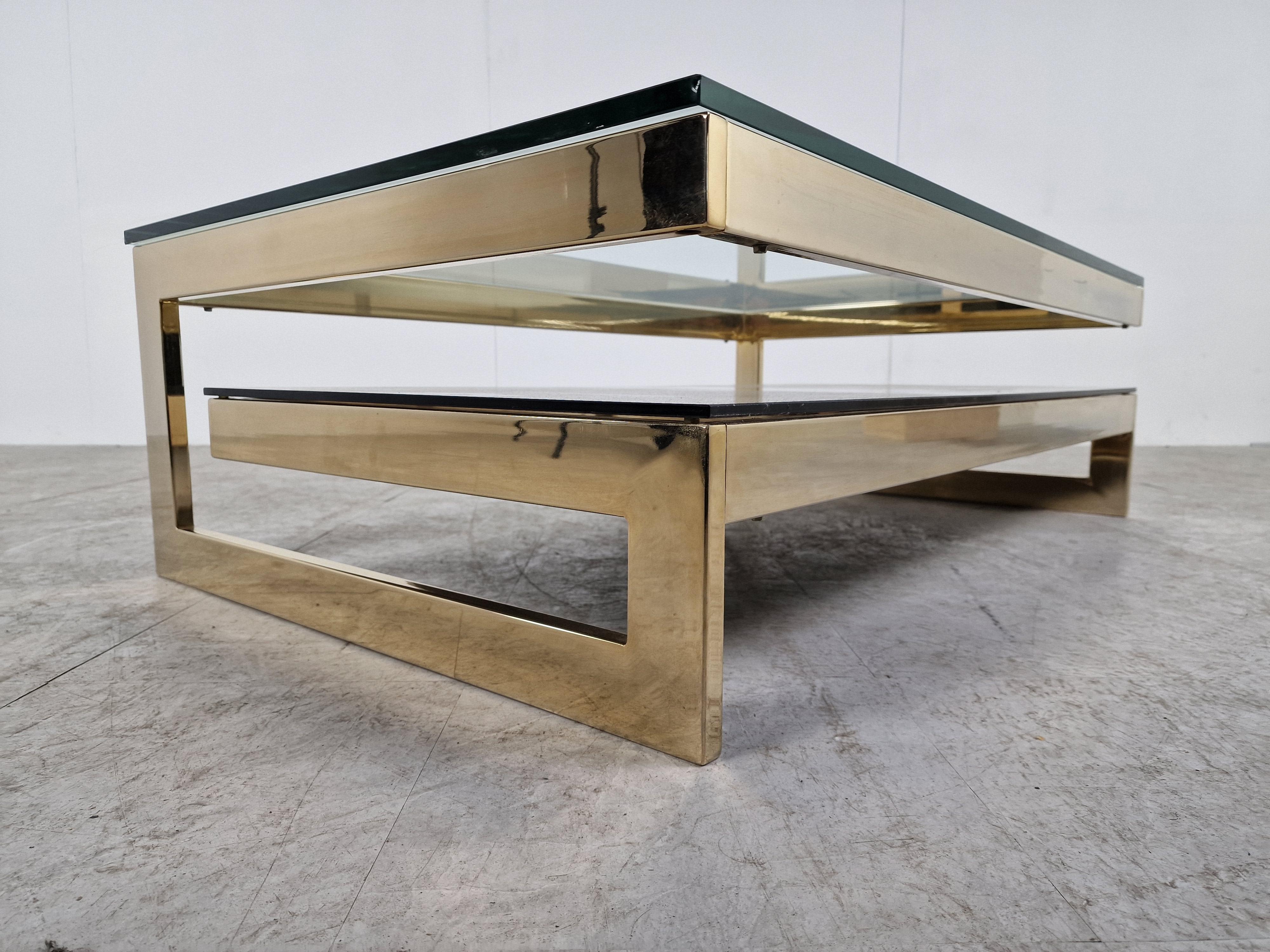 Quality 23kt gold layered and thick clear glass two tier coffee table manufactured by Belgochrom.

This table is a popular model and is referred to as the 'G' model.

Belgochrom produced quality furniture pieces with a luxurious appeal.

Good