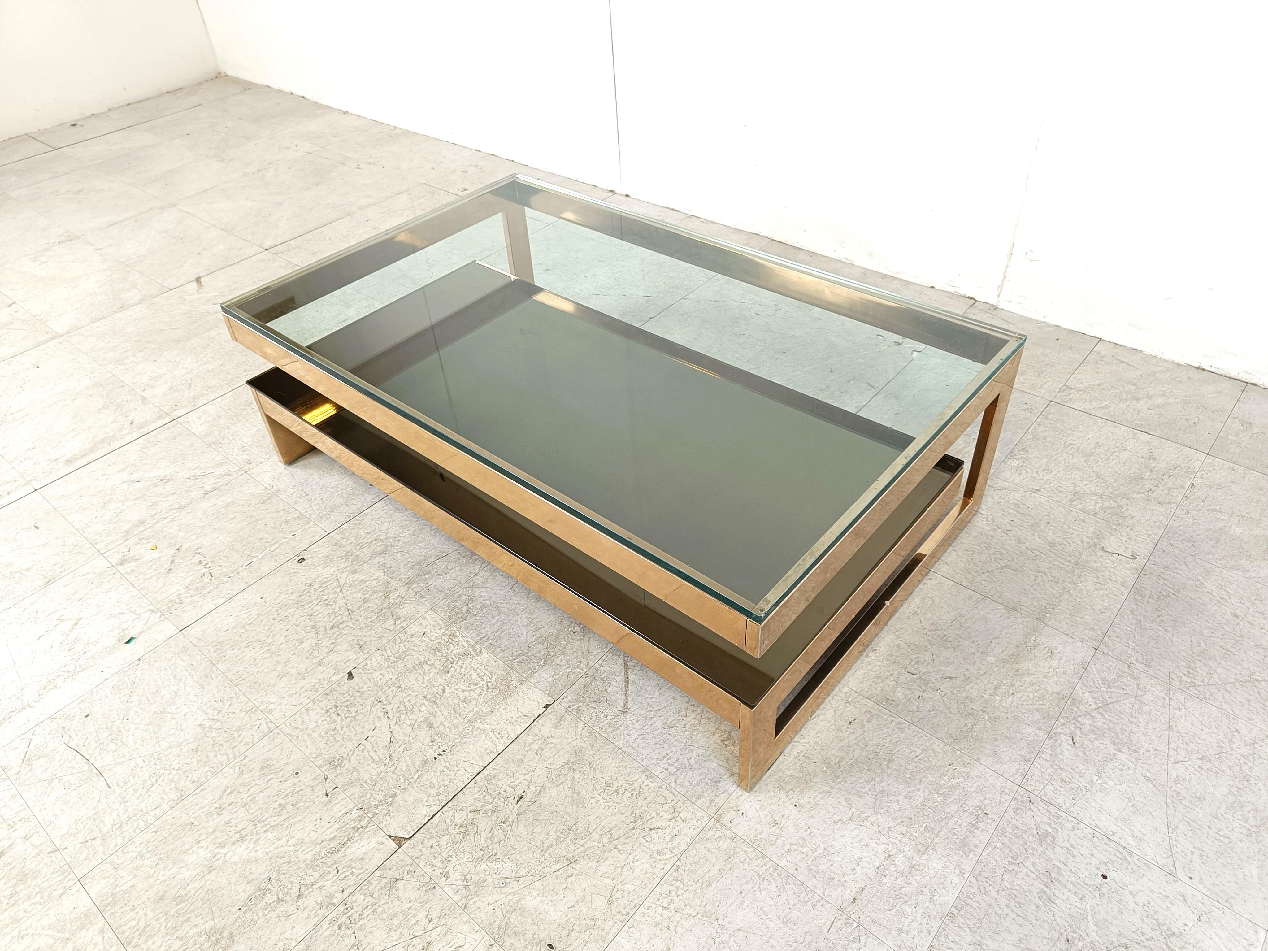 Quality 23kt gold layered and thick clear glass two tier coffee table manufactured by Belgochrom.

This table is a popular model and is referred to as the 'G' model

Belgochrom produced quality furniture pieces with a luxurious appeal.

Good overall