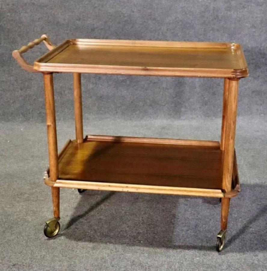 Mid-century rolling tea cart made of wood with brass casters. Great for hosting use or dry bar use.
Please confirm location NY or NJ