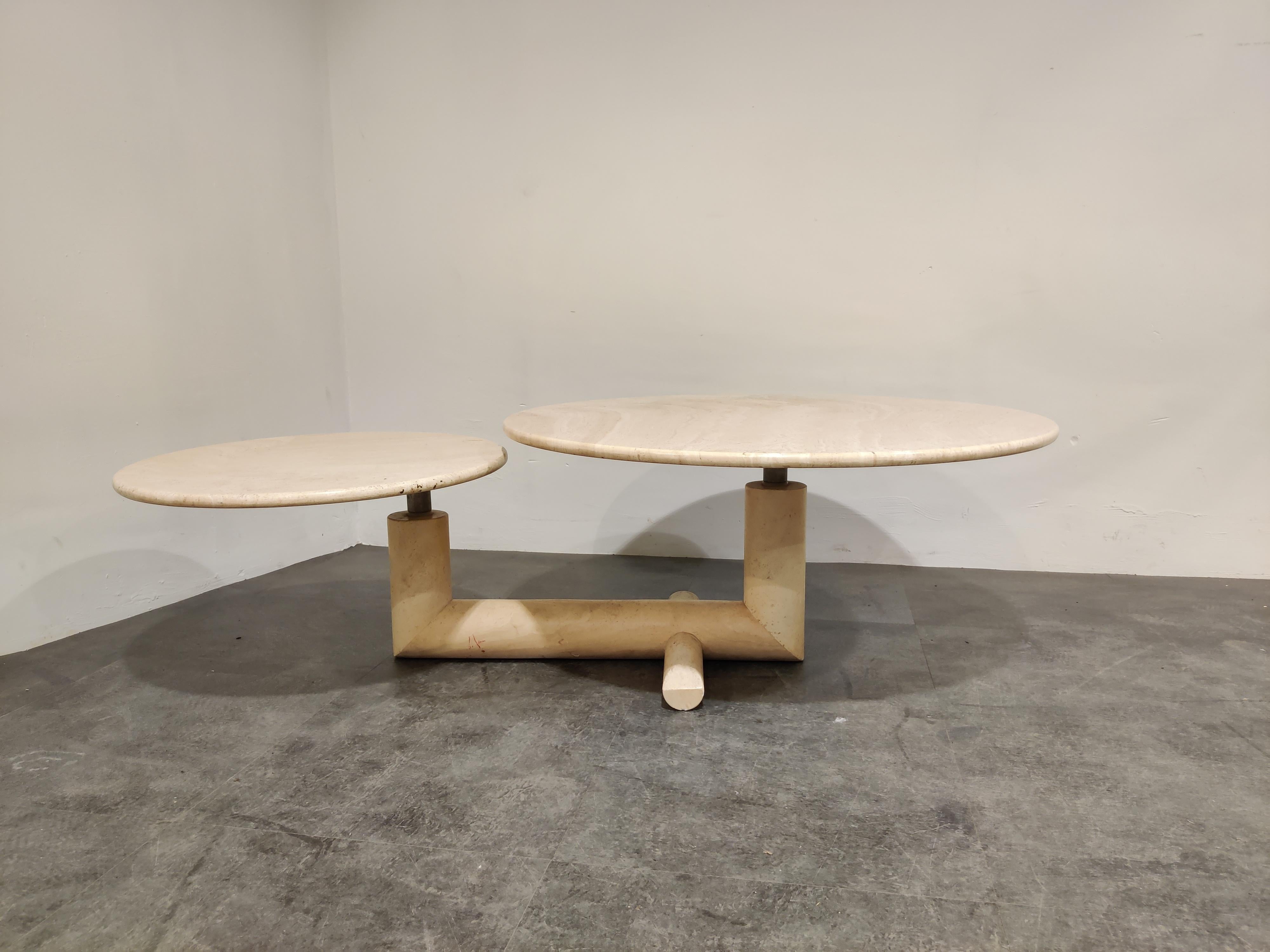 Rare travertine coffee tables with two pivotating round tops.

Unique tubular travertine base.

Good condition.

1970s - Italy

Dimensions:
Height: 41cm/16.14