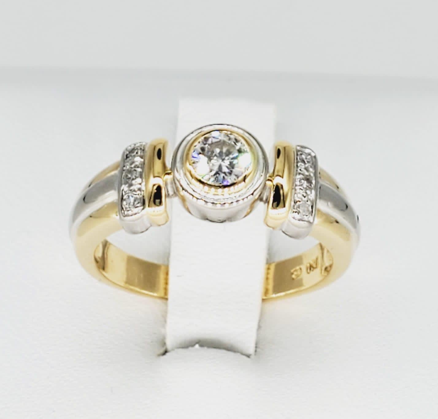 Vintage Two-Tone 0.30 Carat Diamond Bezel Ring. The ring features center 0.20 carat Diamond and 0.10 carat on the sides. The ring is a size 6.75 and weights 6.2 grams 18k gold. The ring is stamped 750 for purity. The diamonds are of Vs/Si clarity.