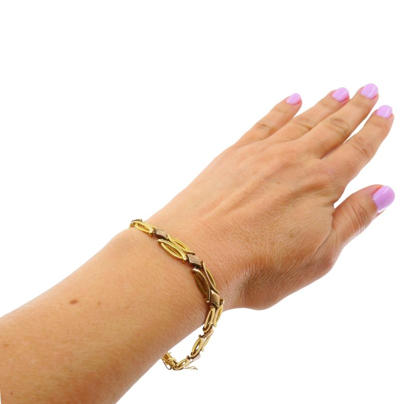A vintage two-tone 14k gold link bracelet. 
The design features alternating open marquise-shaped links in yellow gold and polished diamond shaped connectors in rose gold. The openwork style gives the bracelet a light and airy feel, while a