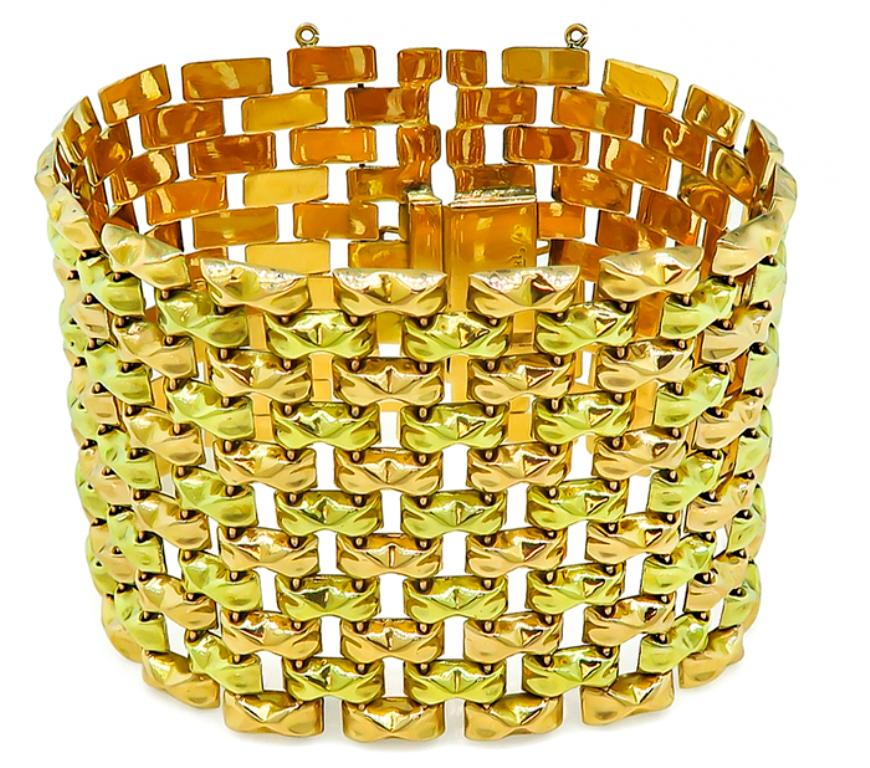 This gorgeous two tone 18k yellow and pink gold bracelet from the Retro era features an amazing geometric design. The bracelet measures 45mm in width and 7 1/2 inches in length. It is stamped 18K and weighs 60.3 grams.


Inventory #16096POSS