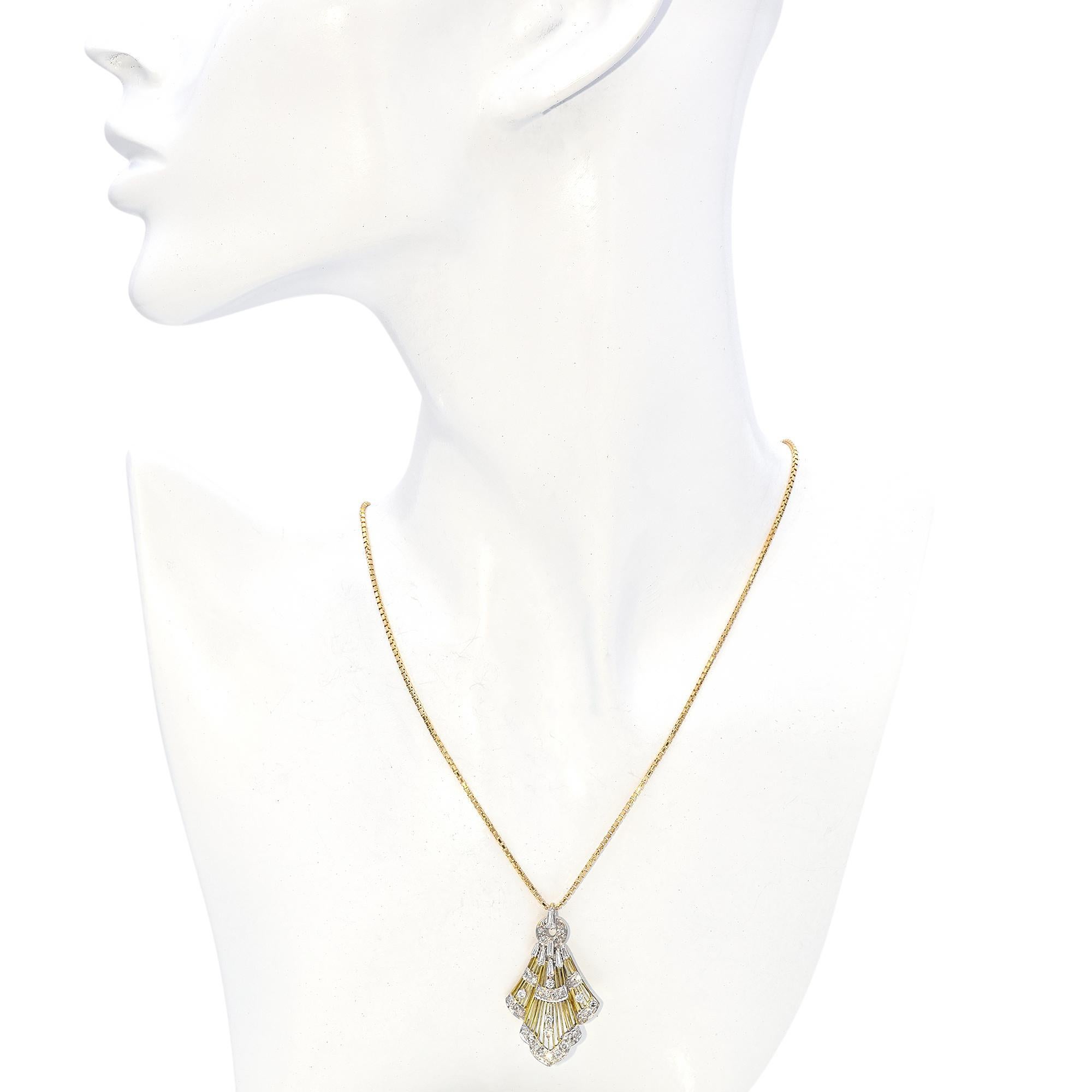 This stunning piece features a unique fan-shaped design, crafted with a combination of yellow and white gold tones. The pendant is adorned with an array of sparkling diamonds, meticulously set to enhance its intricate structure. Baguette and