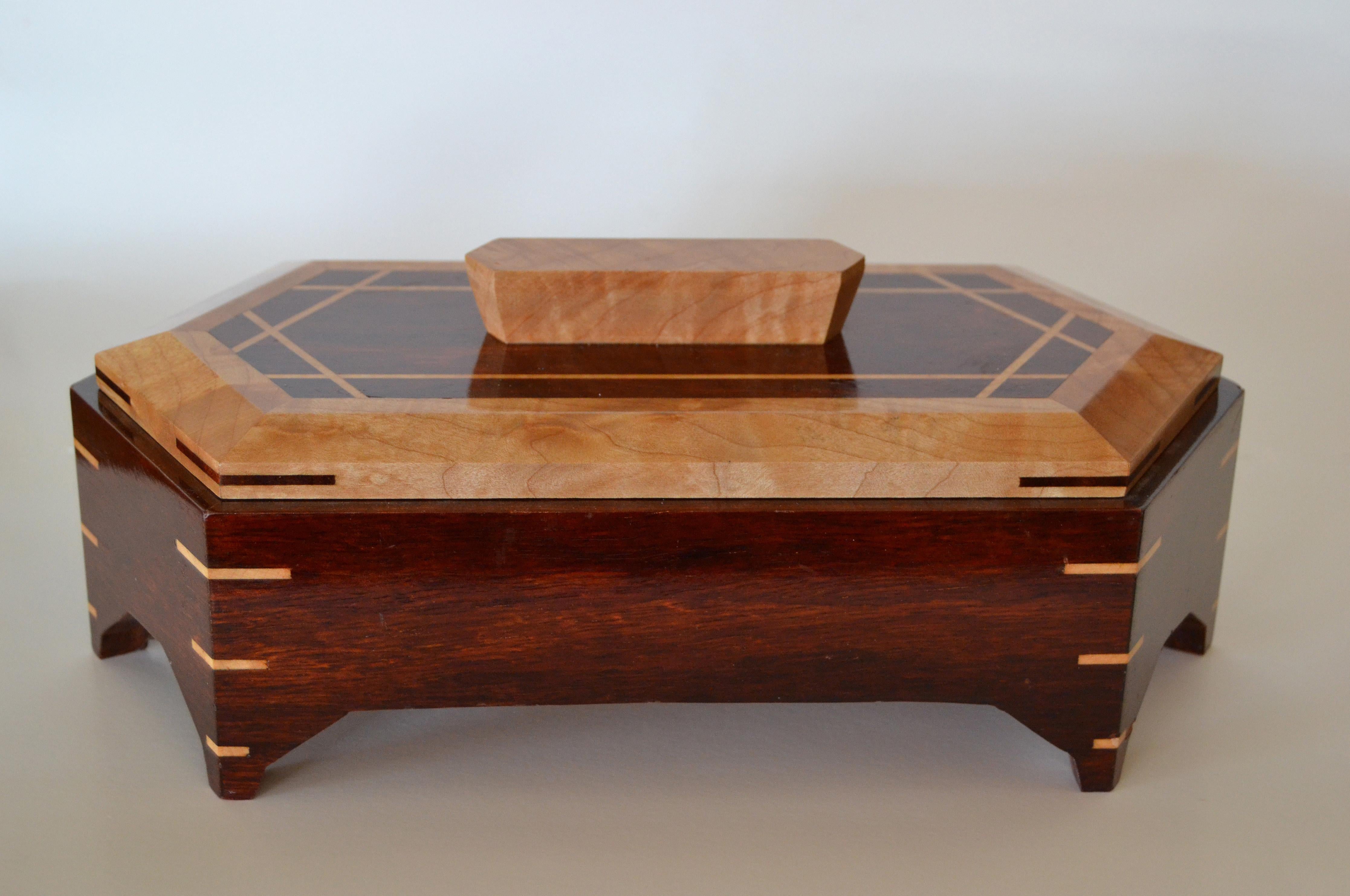 Mid-Century Modern two-tone handcrafted decorative mahogany wooden box with lid.
Look at the very many details in craftsmanship.
Great for jewelry or your keepsake pieces.