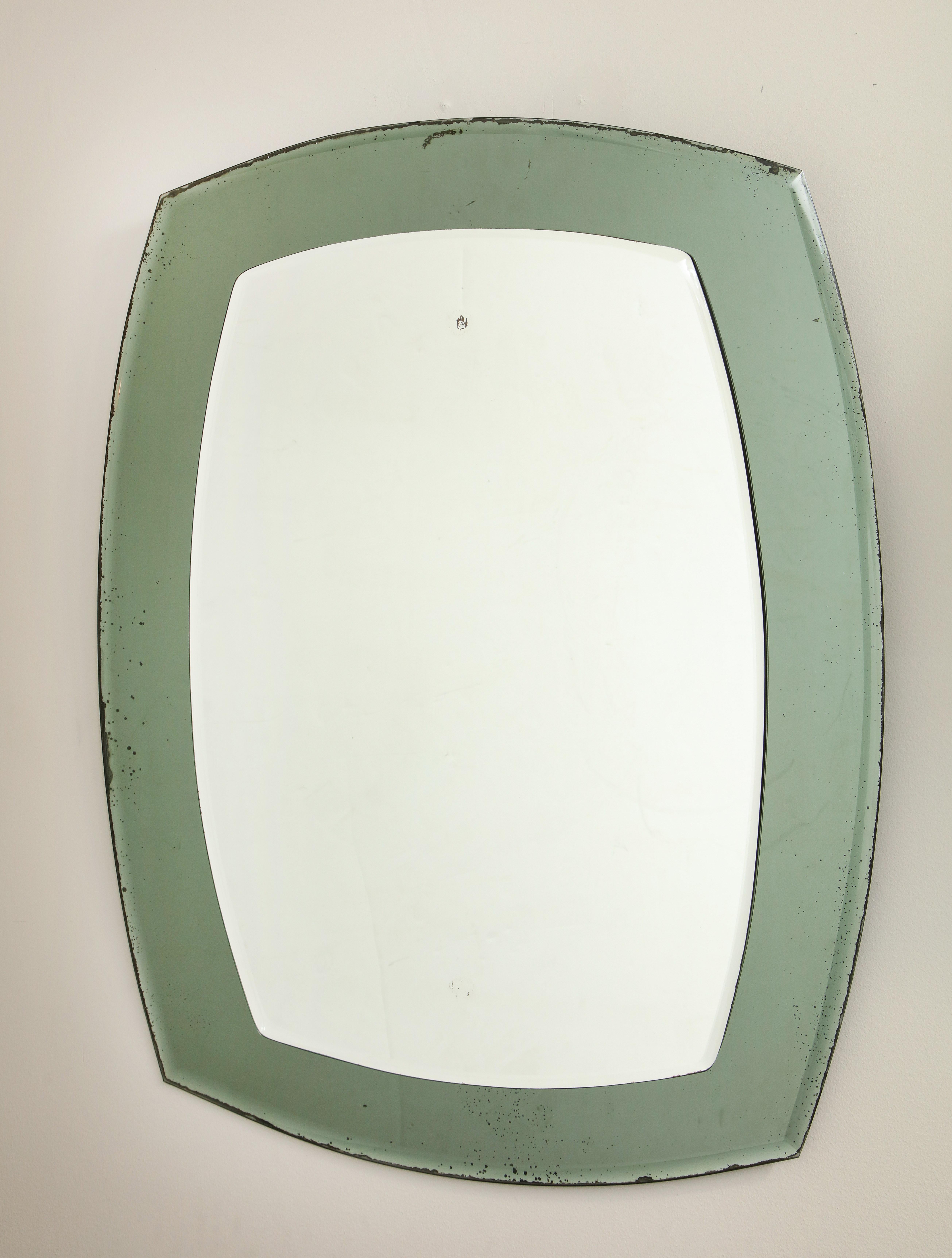 Vintage Italian two-tone mirror in an inflated rectangle shape. It is in vintage condition with some silvering on the mirror that is appropriate with age.