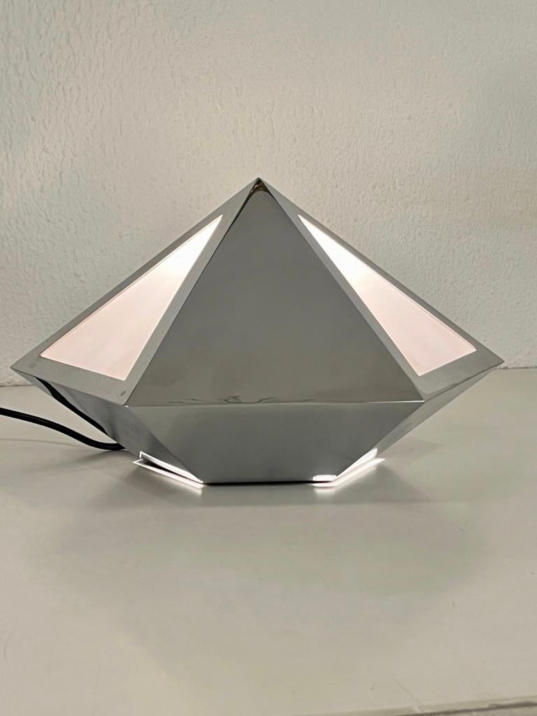 Rarísima lámpara de mesa piramidal cromada fabricada por Banci Firenze en Italia hacia la década de 1970
Etiqueta del fabricante. Muy buen estado. P 35 x A 22 cm
