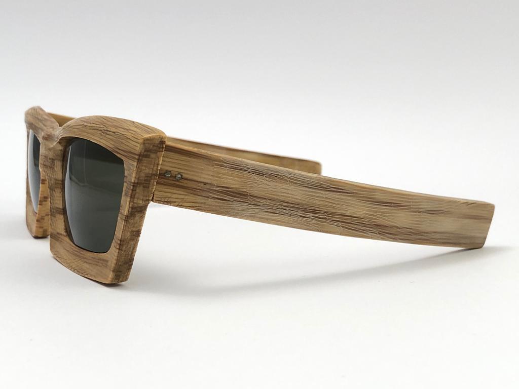 Rare and seldom piece of Oliver Goldsmith Handmade in 1960'S sunglasses. 


A piece rarely seen up for sale. Acetate frame shaped by hand to simulate real wood carving. A camera can't capture the craft and the real feel of this piece. A truly one of