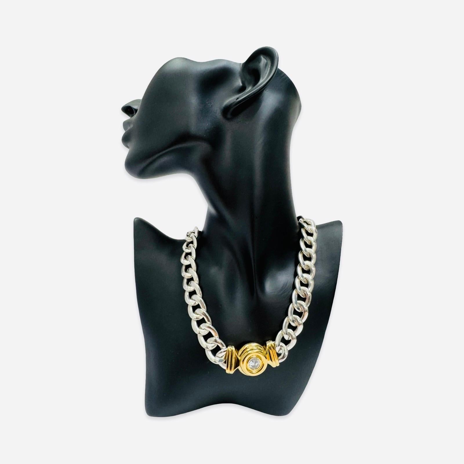 A striking vintage Unaree designer necklace crafted in heavy sterling silver with warm gold-tone accents. Weighing a substantial 99 grams, this 17-inch piece features a classic Italian curb-link construction and a bold 25mm sculptural center motif