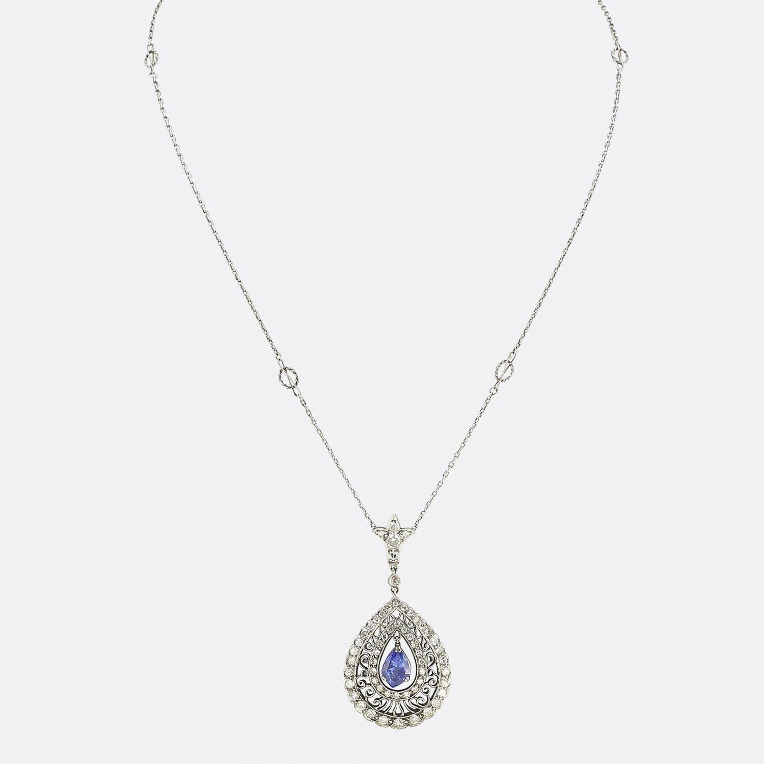 This is a magnificent vintage sapphire and diamond drop necklace. The necklace features a central unheated blue sapphire that has been claw set and moves freely within the setting. Surrounding the sapphire are two halos of single cut diamonds with