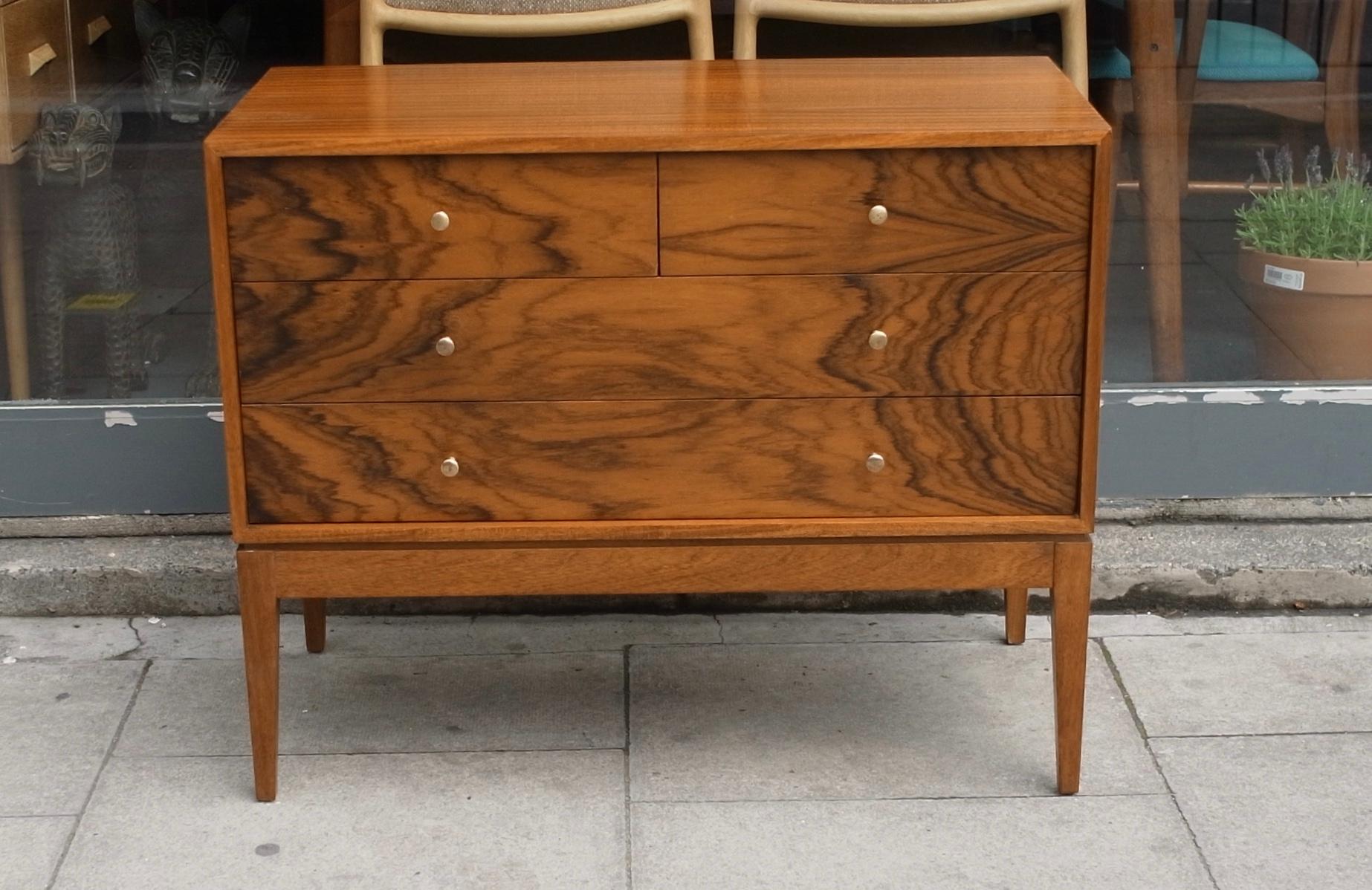 A very beautiful, and stylish vintage Mahogany and Indian Blackwood British made 1960s chests of drawers, set on solid Mahogany tapered legs. This chests of drawers designed by Peter Hayward and produced by Uniflex, incorporates two small Indian