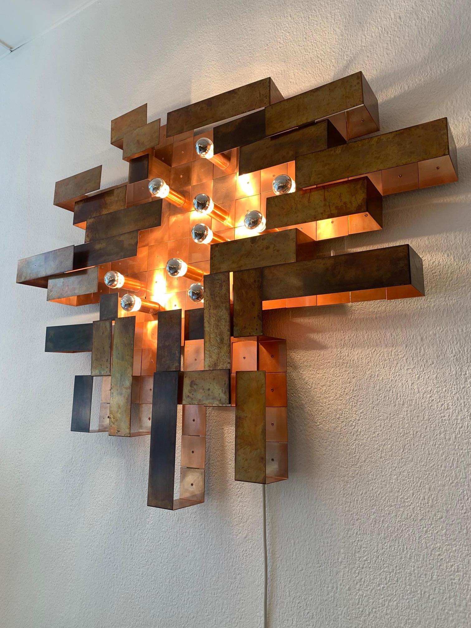 Unique, made on order, huge copper asymetrical brutalist wall lamp ca. 1970's
Probably made in Switzerland, highly decorative
10 E14 standard bulbs (mirrored) Can be used with new LED copper color bulbs 
Beautiful patina (oxydation on copper)
Comes