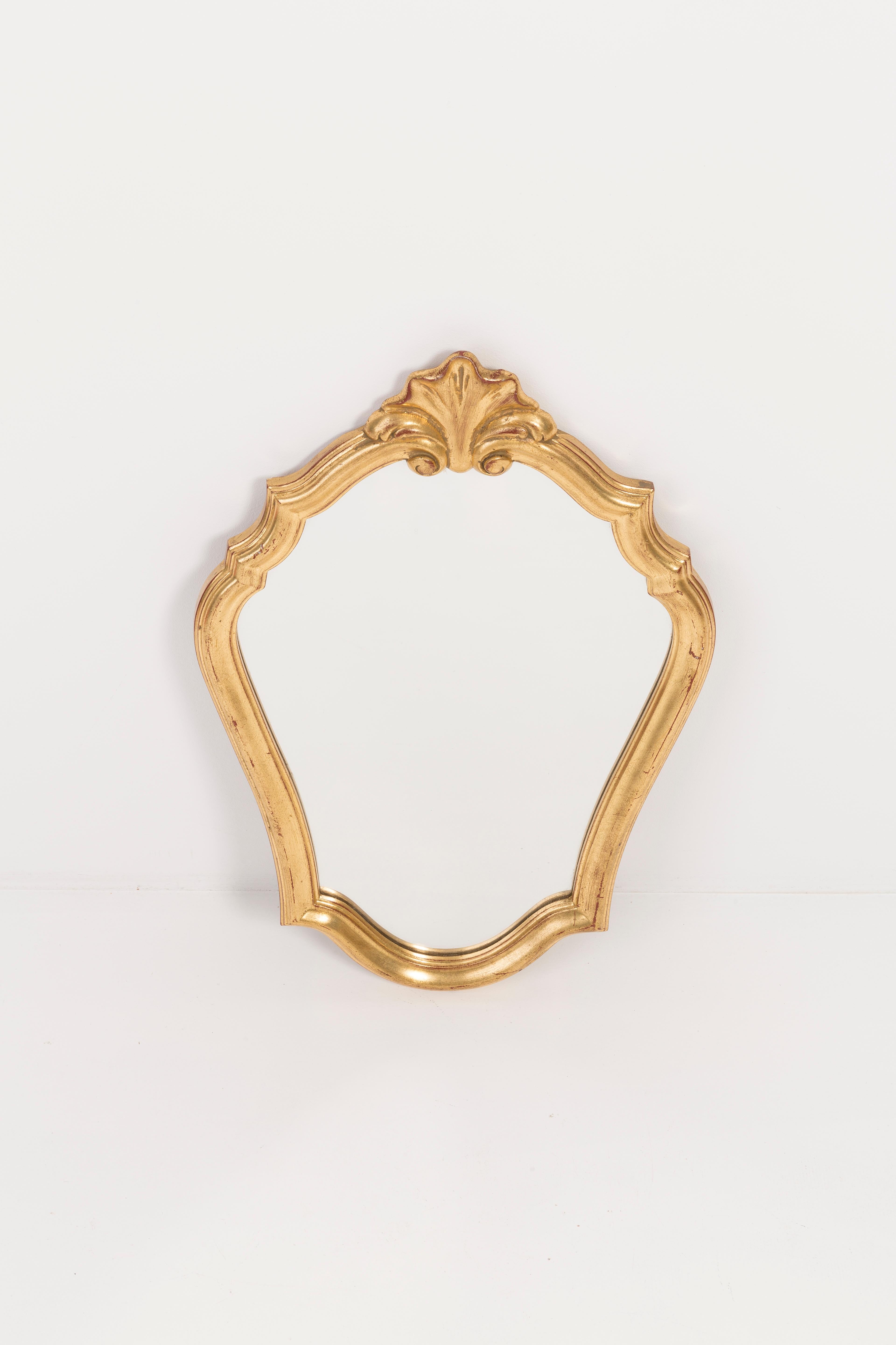 A mirror in a golden decorative frame from Belgium. The frame is made of wood. Mirror is in very good vintage condition, no damage or cracks in the frame. Original glass. Beautiful piece for every interior! Only one unique piece.