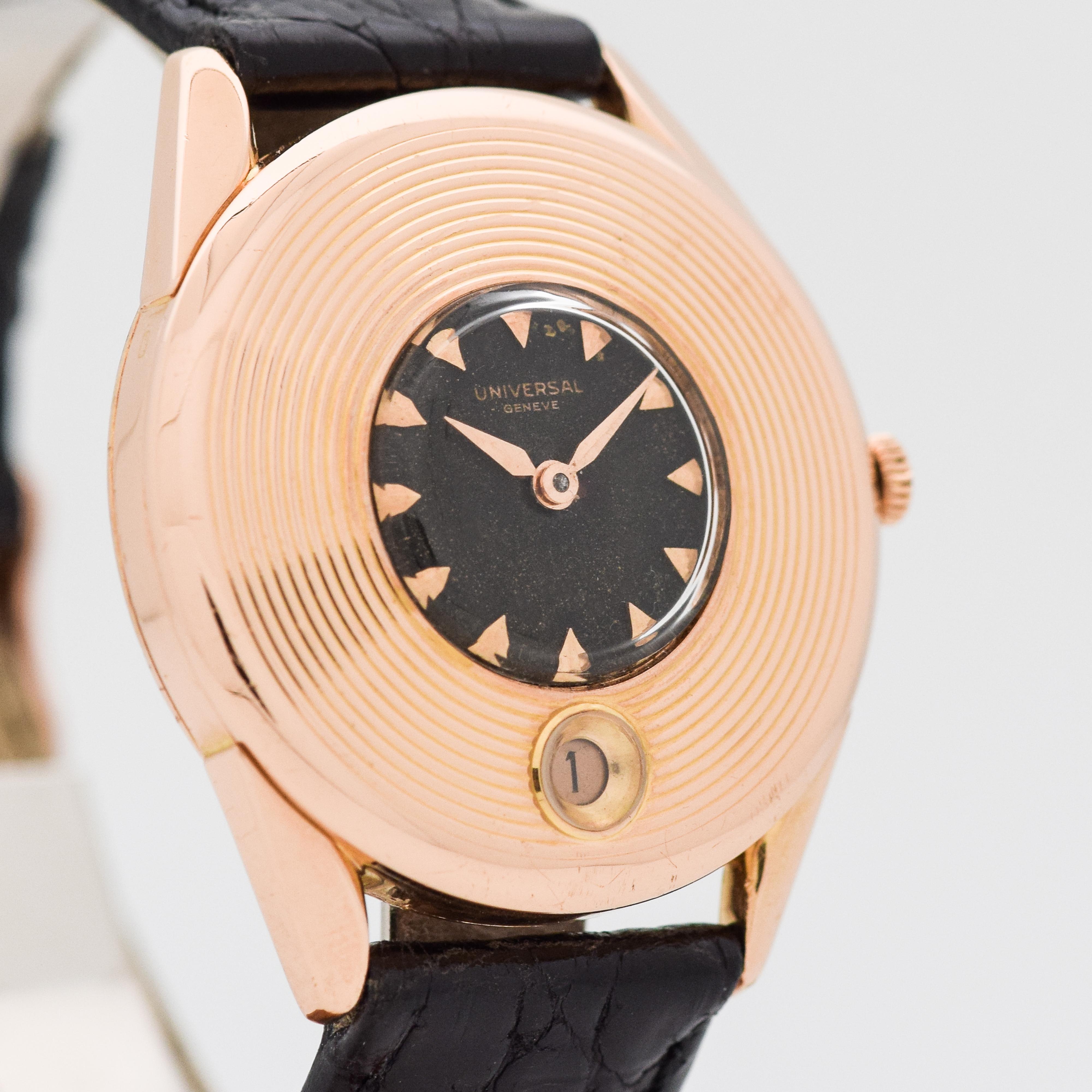 1956 Vintage Universal Geneve 18k Rose Gold Rare Unusual Ridged Bezel Case with Original Black Dial with Applied Beveled Triangle Rose Gold Markers. 34mm x 39mm lug to lug (1.34 in. x 1.54 in.) - 17 jewel, automatic caliber movement. Triple Signed.