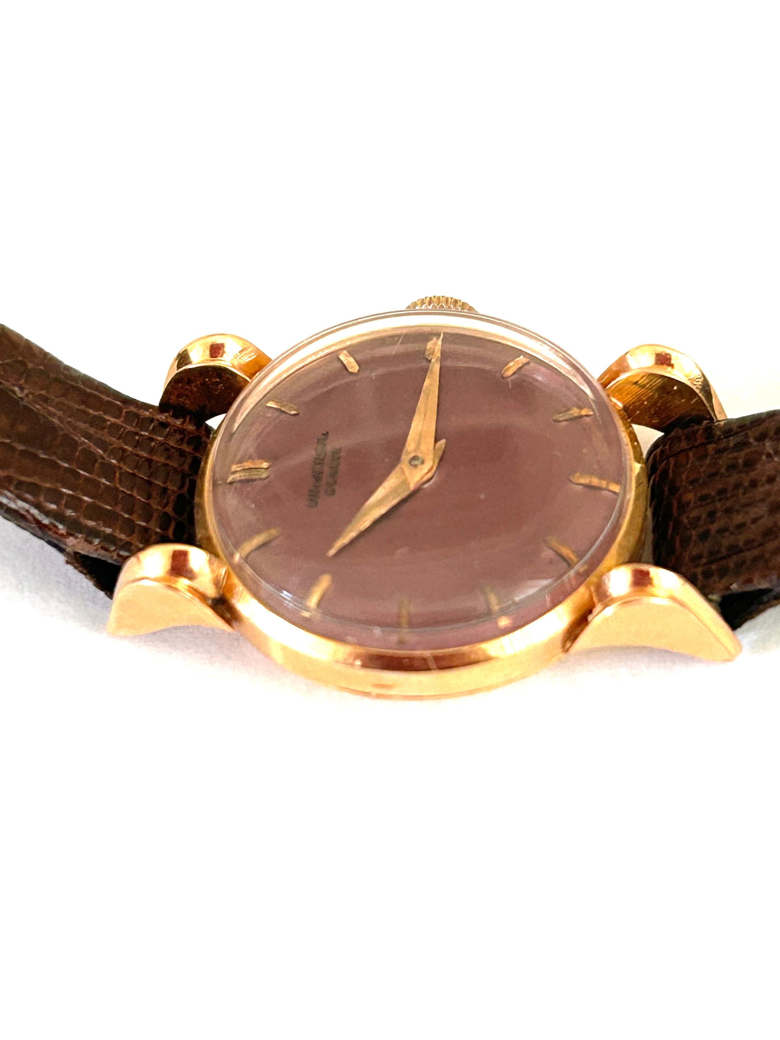 Rare Universal Geneve 18k rose gold ladies wristwatch, circa 1950, case universal geneve serial number #1402058173323. Violet purple watch face, with Universal Geneve on face, 18K rose pink gold : time numerals, buckle closure, case. Face measures