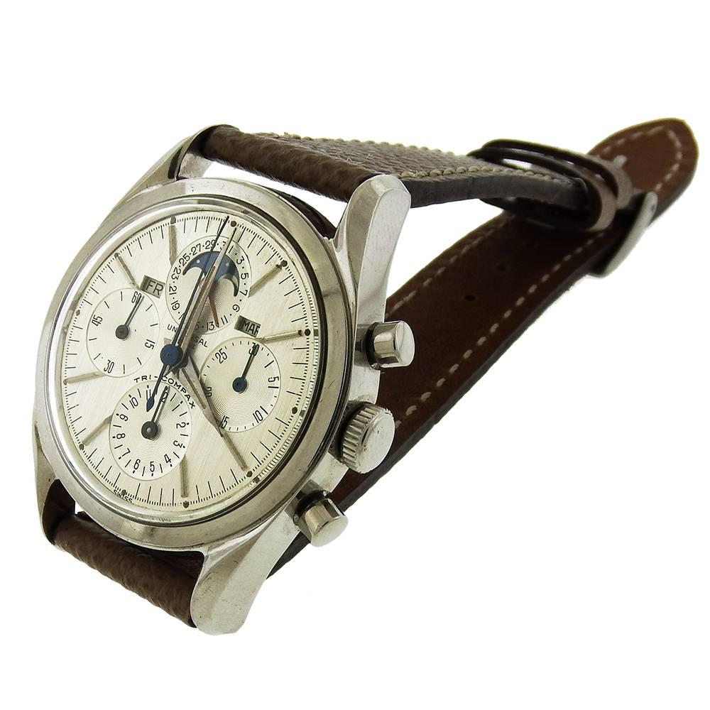 Stainless steel Universal Geneve, Ref: 222100-1, Tri-Compax, circa 1960, is a vintage chronograph in excellent condition. The 36mm case has a screwed-down back, flat bezel, silvered vertical brushed dial with four registers -- constant seconds, 30