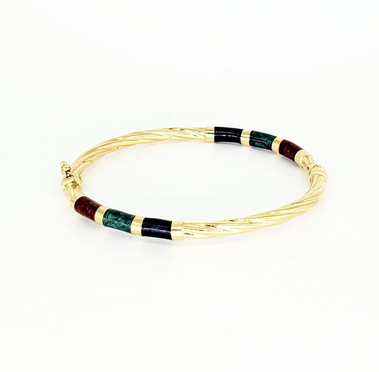 Vintage UnoAerre Enamel Bangle 18k Gold. Marked UnoAerre and 750 Italy. The bangle weights 8.6 grams and made in 750 18k gold. Beautiful swivel design featuring Red Ruby, Blue Sapphire & Green Emerald enamel. The bangle measures 2”x2.5” and is 3.8mm