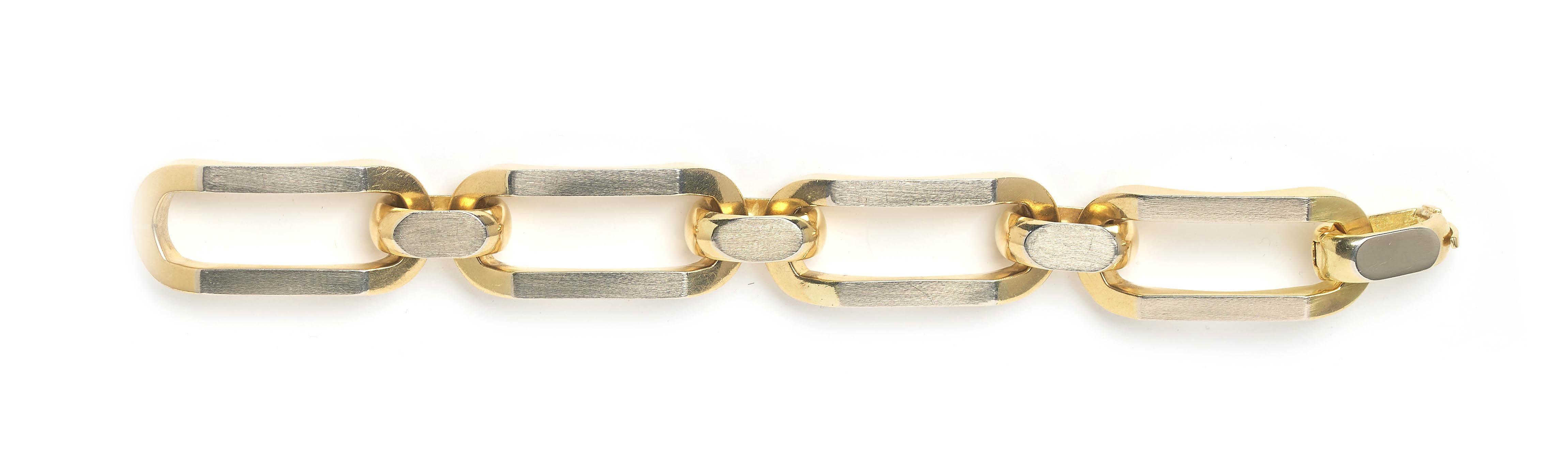 An Italian 18ct gold and platinum chain link bracelet, by UnoAErre, featuring chunky long and short links, with a satin finish, platinum overlay on the gold links. The long links are curved for a comfortable fit, with an invisible clasp, stamped
