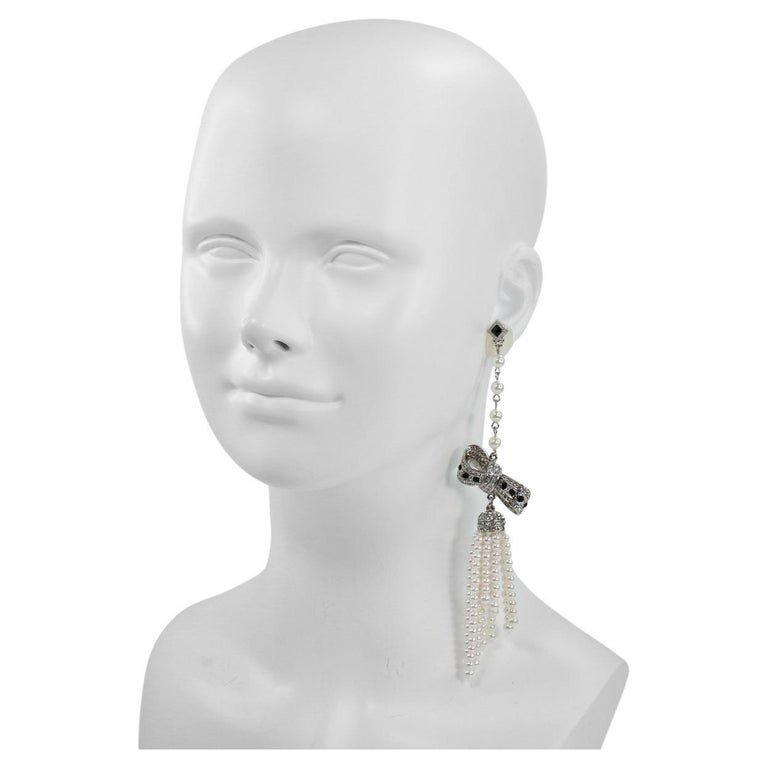 Vintage unsigned long dangling pearl and rhinestone bow earring circa