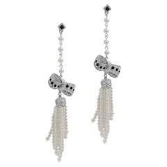 Retro Unsigned Long Dangling Pearl and Rhinestone Bow Earring, Circa 1990s