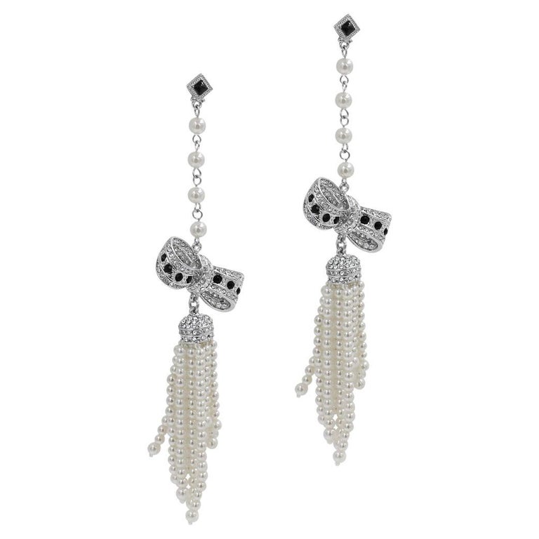 Vintage unsigned long dangling pearl and rhinestone bow earring circa