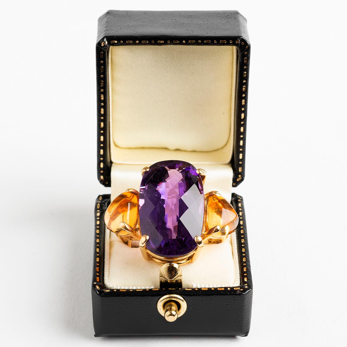 A unique and stunning statement piece, which we date to circa 1960s, and truly evoking the period, our large and notable dress ring in 18k yellow gold features a prominent rose cut amethyst and citrine stones. A worthy addition to any quality