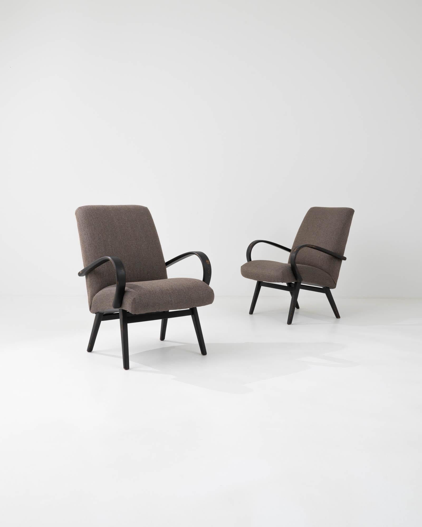 This pair of vintage armchairs is a product from the mind of the renowned industrial designer Jindřich Halabala. Celebrated along with other pieces of postwar Czechia, belonging to collections of museums across Europe they use the characteristic