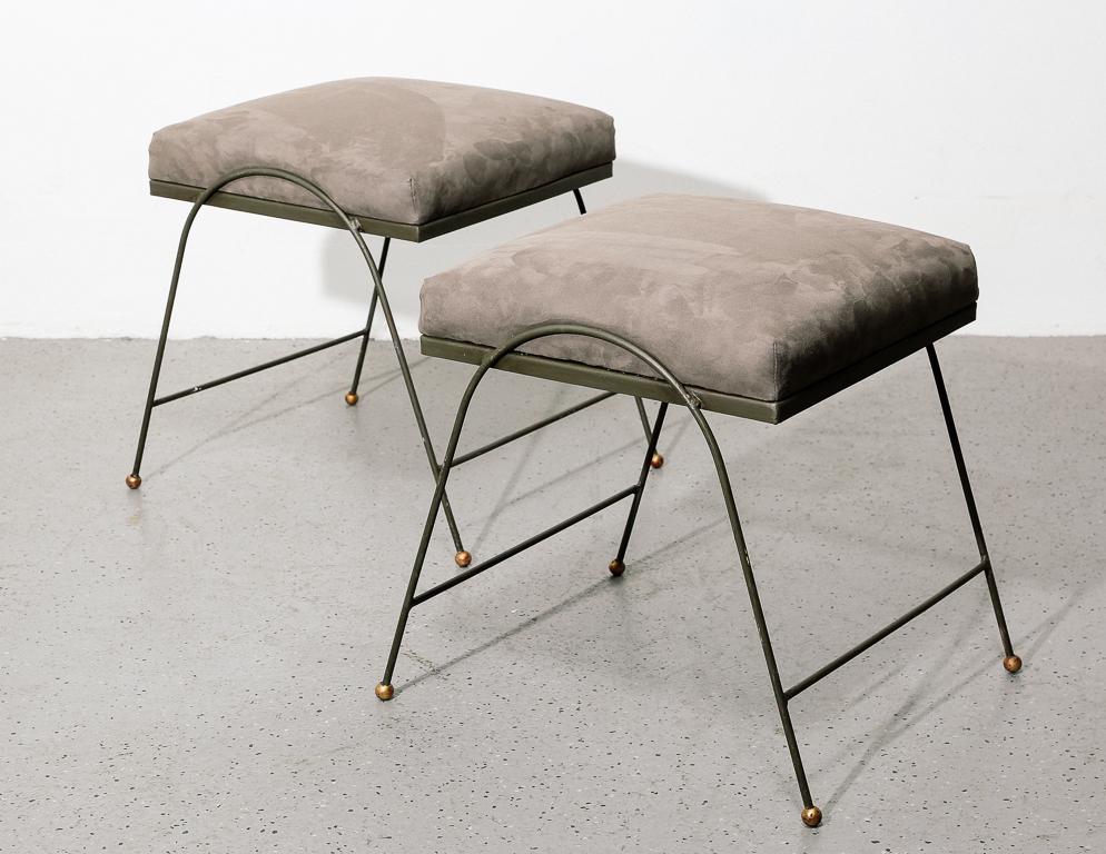 Vintage bent iron footstools with brass details. Upholstered in grey micro suede. Sold individually.
