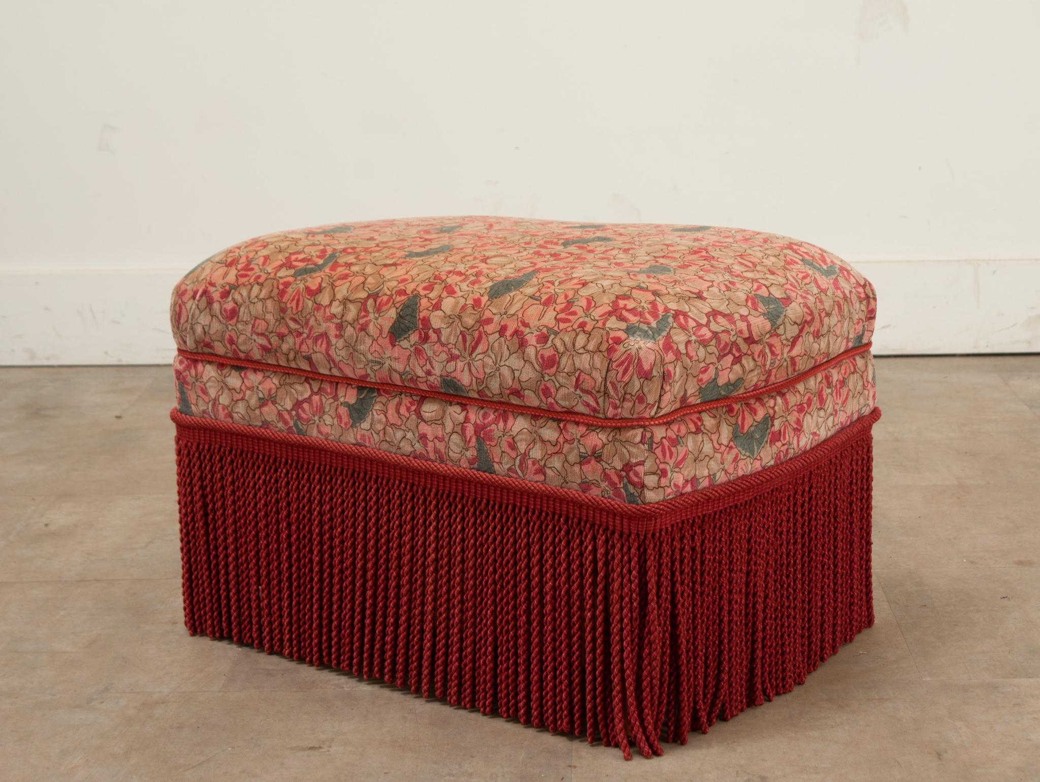 A French vintage stool upholstered in a multicolored floral print fabric with coordinating fringe. The top lifts off to reveal a storage cavity 8”H x 18 ⅛”W x 13”D. Be sure to view the detailed images to see the current condition of this vintage
