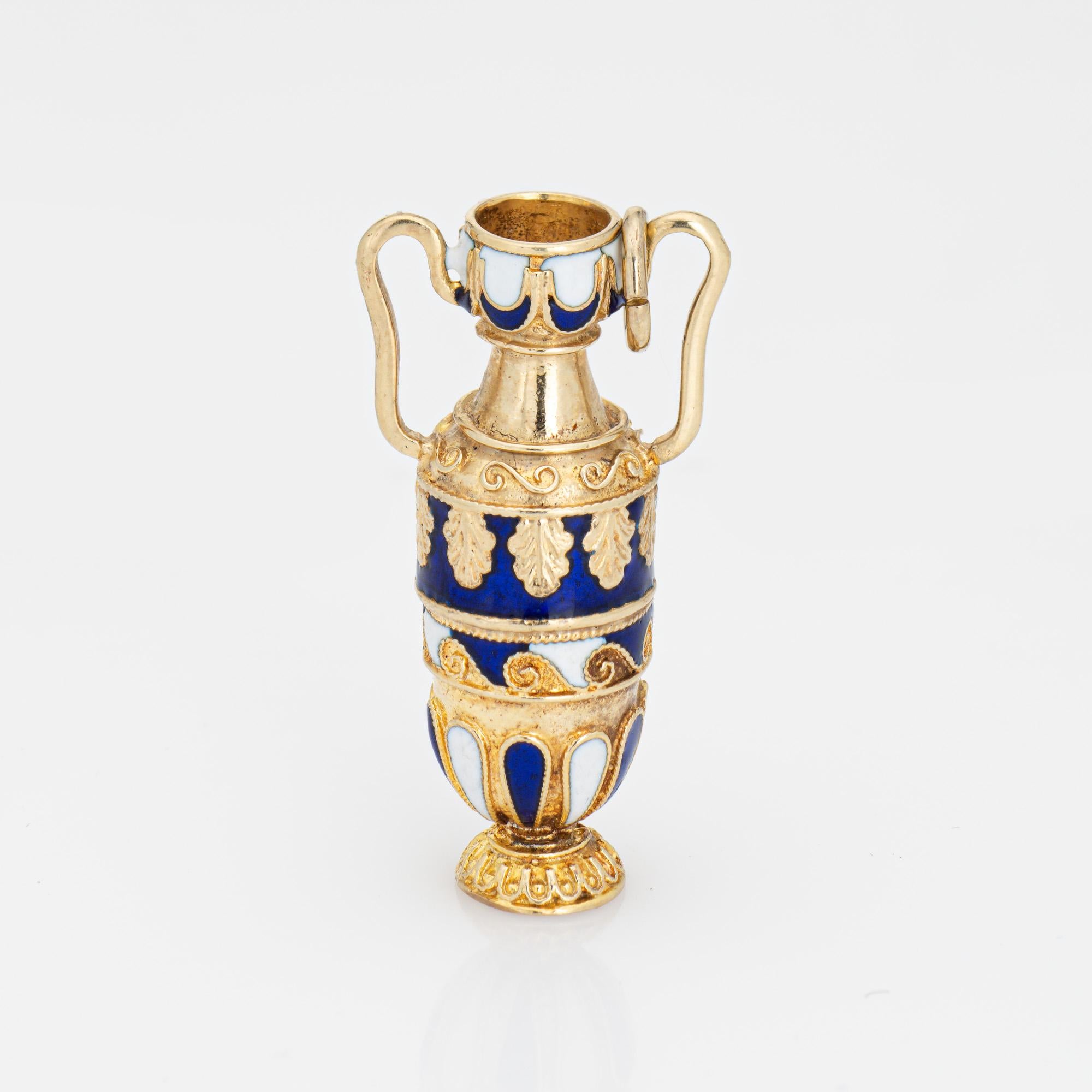 Finely detailed vintage urn charm crafted in 14k yellow gold.  

Blue and white enamel adorns the charm. 

The beautifully detailed charm highlights ornate blue and white enamel. An amphora is a type of container used to transport and store various