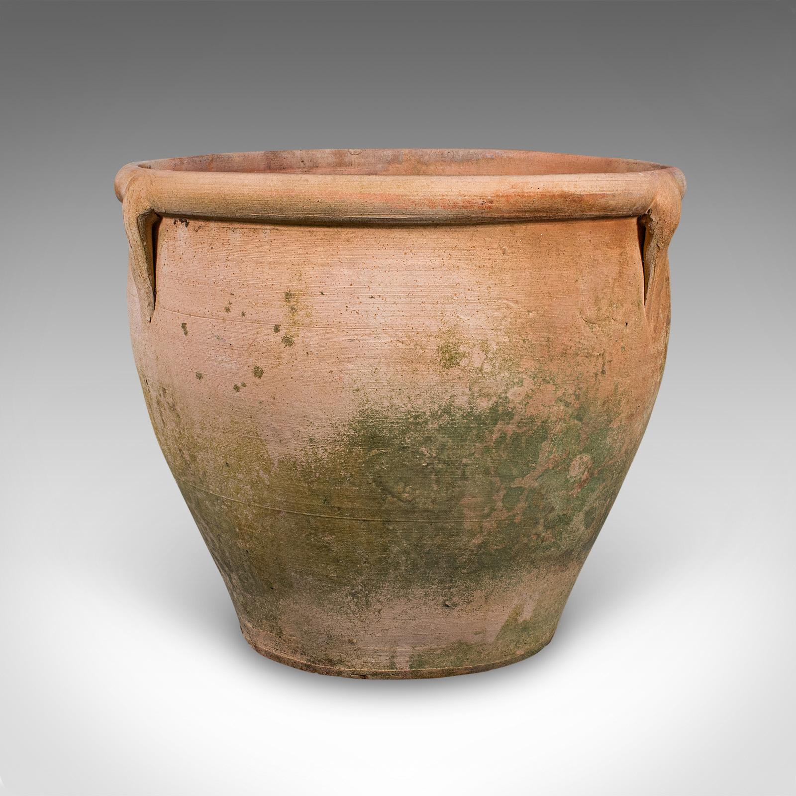 This is a vintage urn planter. An Italian, terracotta patio jardiniere, dating to the mid 20th century, circa 1960. A charmingly Italianate planter, presenting classic form and decorative appeal.

Delightful urn-shaped planter with timeless Italian