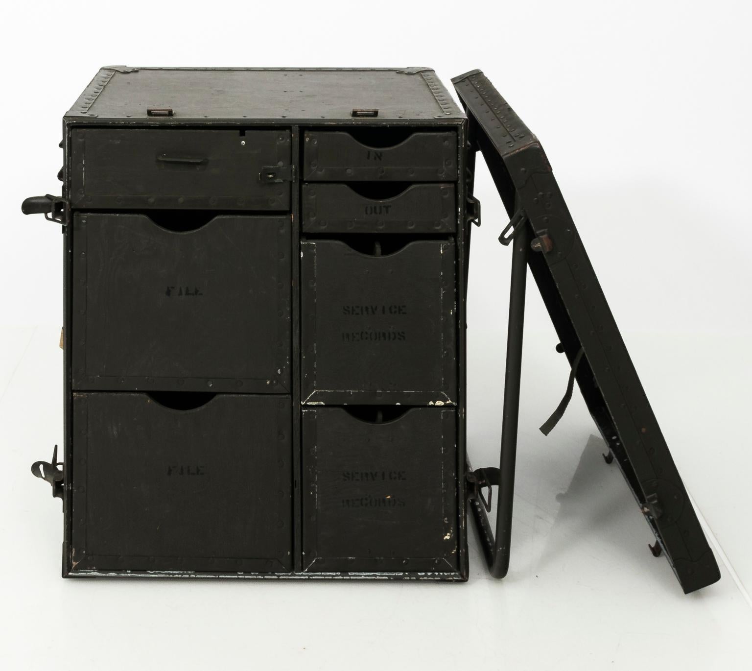 World War II era portable headquarters desk for the US. Army. Fully foldable with removable lid and seven labeled drawers. When closed it measures 23.50 inches wide by 27.50 inches height by 18.00 inches depth, circa mid-20th century.
 