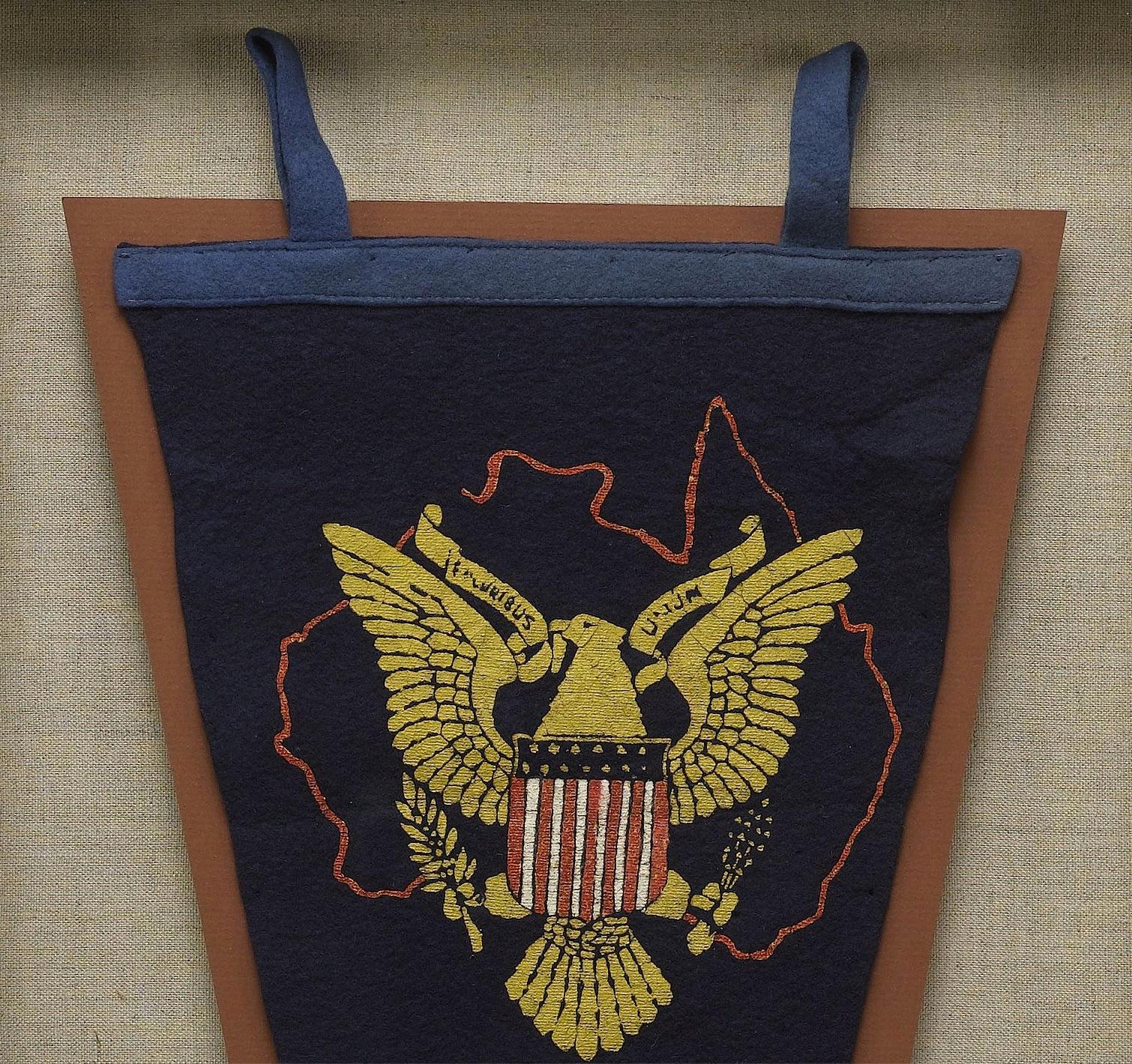 Presented is a souvenir felt pennant celebrating the servicemen and women of the U.S. Navy who were based in Australia and fought alongside members of the Royal Australian Navy during WWII.  The navy blue pennant is printed with the red outline of