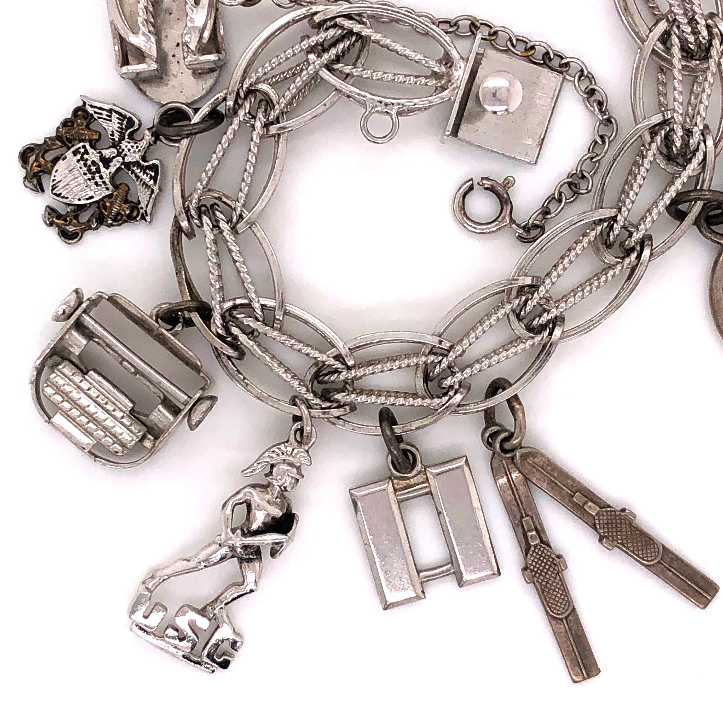 Collectible Vintage USC Sterling Silver Charm Bracelet. Navy Crest Typewriter USC Trojan Unknown Snow Skies Heart Engraving Cactus USC Crest Plaque $5 US Bill in display Box. Bracelet measures approx. 7.5” Long Circa 1971. In excellent condition.