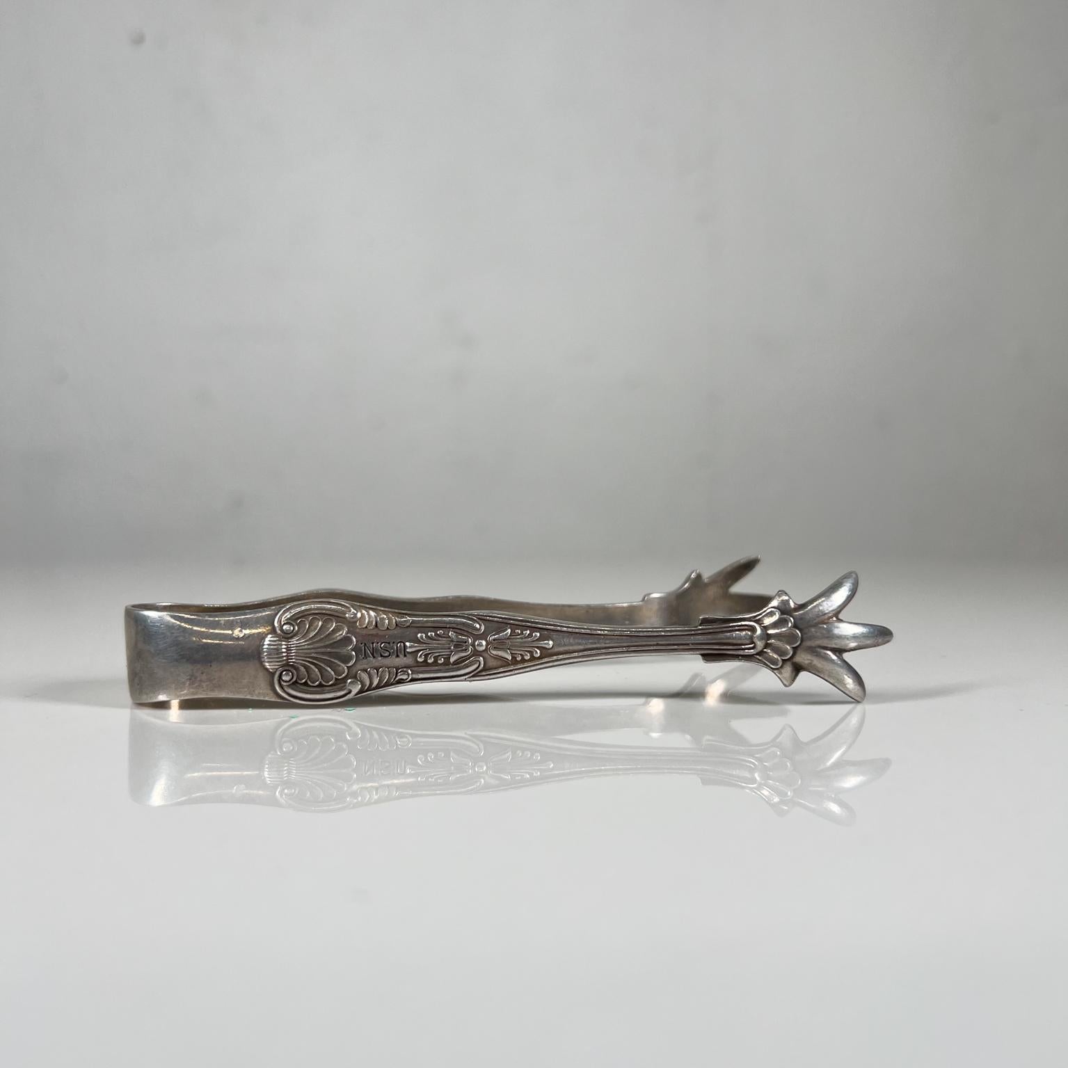 Vintage USN silver claw sugar ice tongs decorative design Eagle
Measures: 4.5 Long x .63 tall x 2 width
Small tongs for sugar or ice cubes.
Stamped-marked USN
Beautiful decorative claw details
Preowned vintage unrestored, refer to images