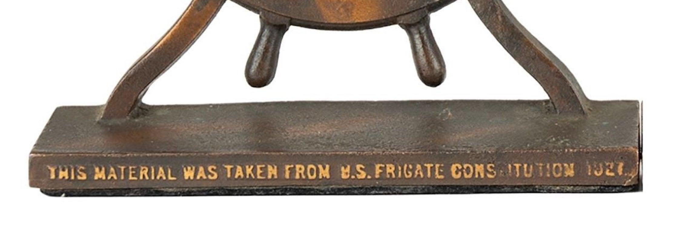 Presented is a foundry cast bronze plaque made from metal reclaimed during the 1927 restoration of the famous frigate USS Constitution. The plaque features a ship's wheel on a base, which reads: 