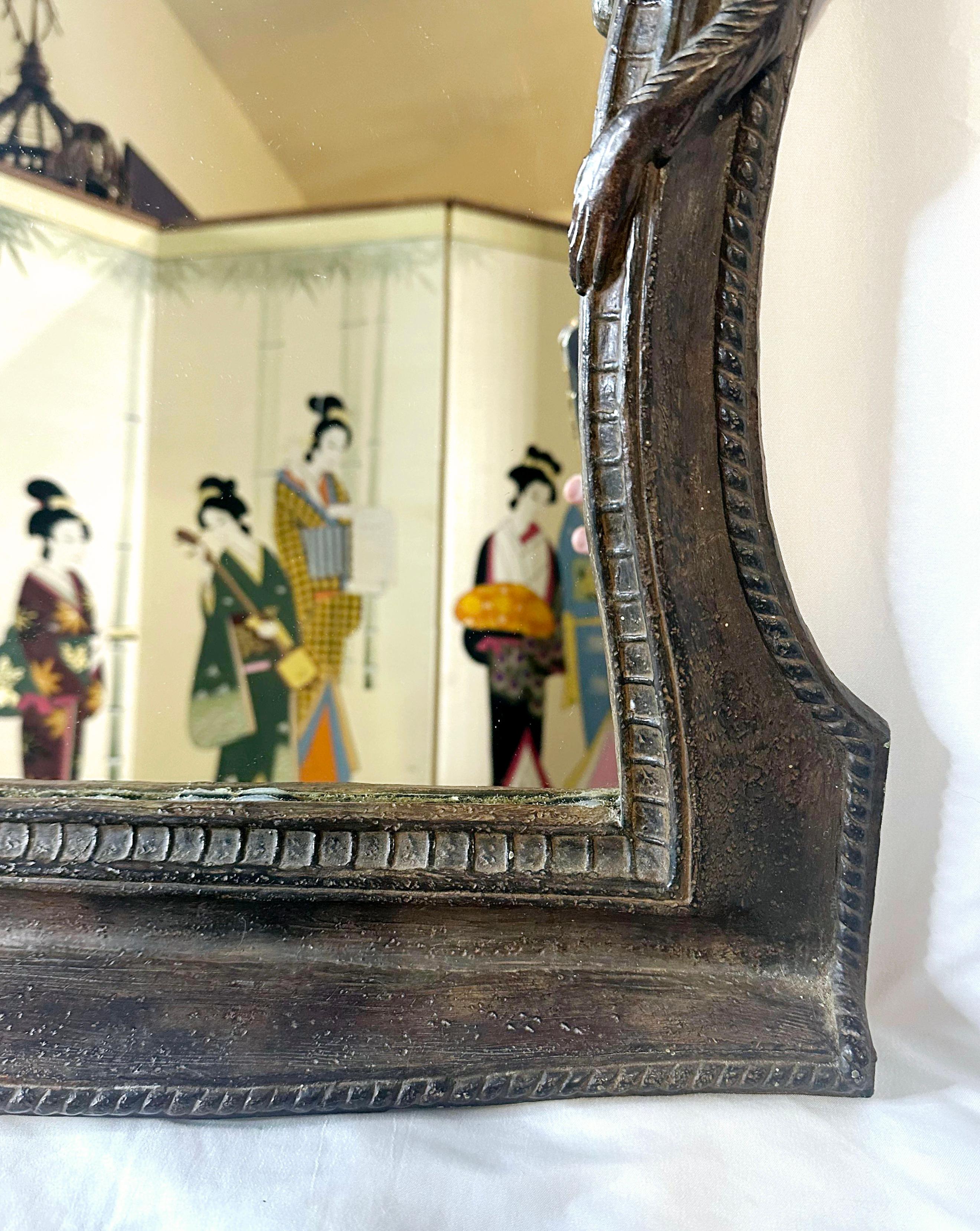 Reminiscent of Earnest Hemingway, Maitland Smith and Tommy Bahama.
Would also be at home in Indiana Jones' study.
Tropical, figurative mirror with two bellhop monkeys.
Small decorative shelf.
Hanging hardware and picture wire installed. 
I think