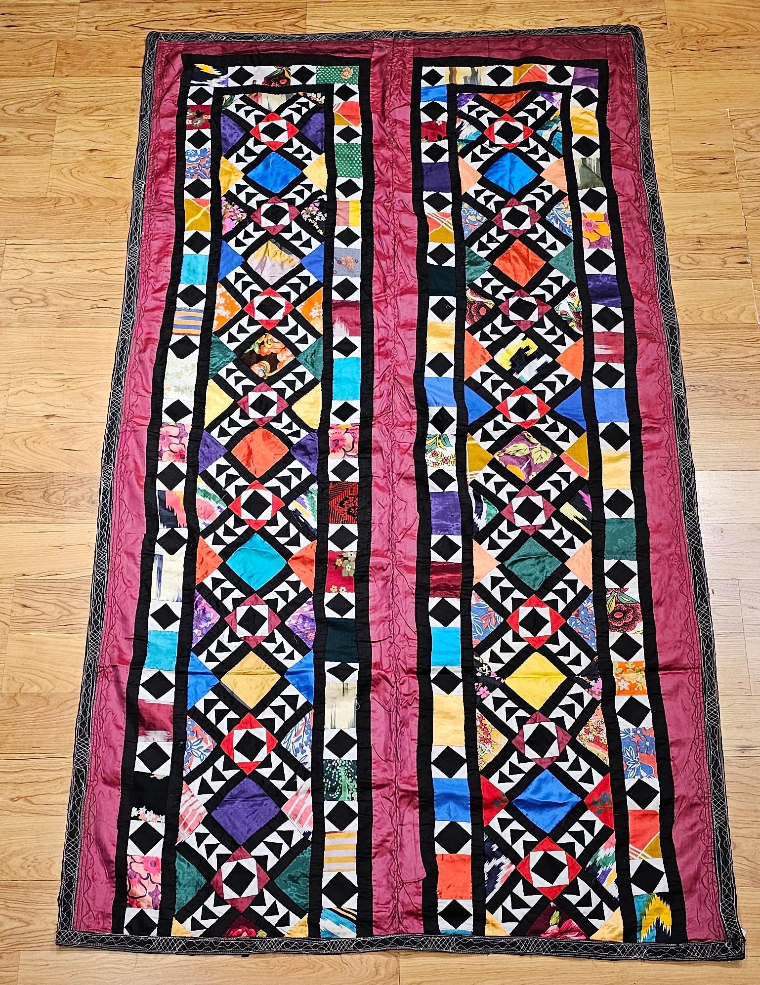  Beautiful vintage hand-stitched “pieced” silk quilt from Uzbekistan in Central Asia from the mid 1900s.  The silk fabric pieces are cut in geometric form and some of them have the design on them.  The vibrant colors are red, green, yellow, blue,